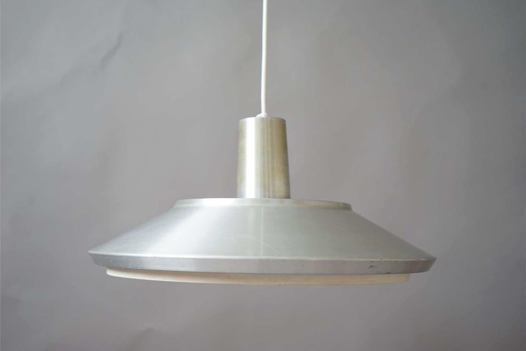 Metal mid century pendant light, circa 1960's. This light features metal shade with original diffuser. Small melted area of diffuser.

A classic Scandinavian design to brighten up any area of your home.