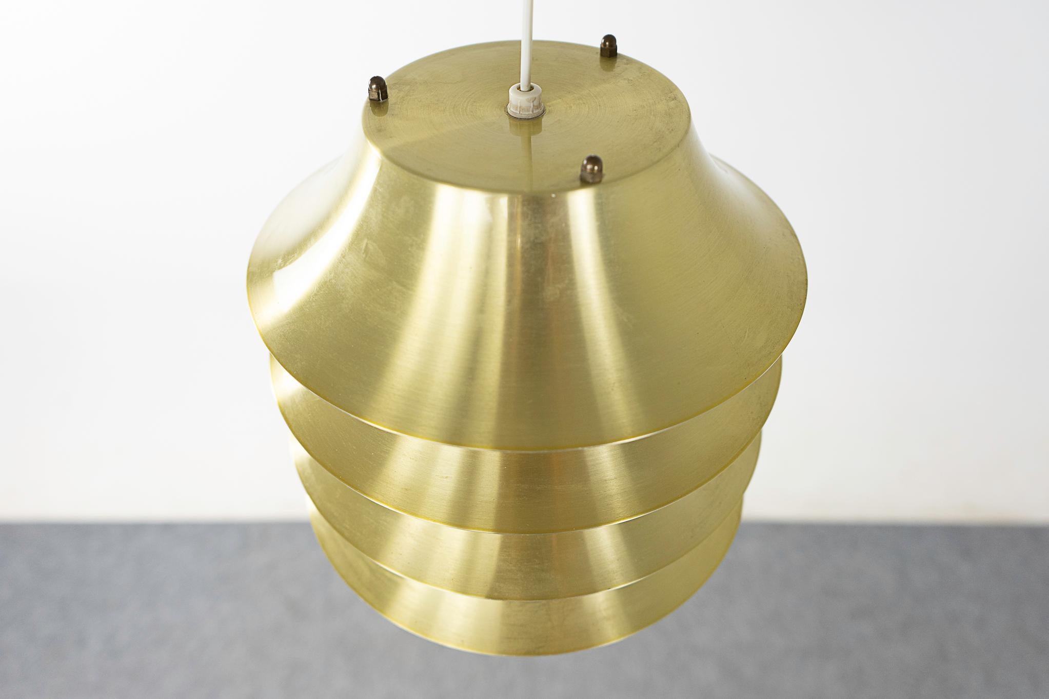 Brass pendant light, circa 1960's. Multiple sculptural layers offer a soft diffused light.  Compact, unique design, the perfect addition to any corner or hall! 

Please inquire for remote and international shipping rates.