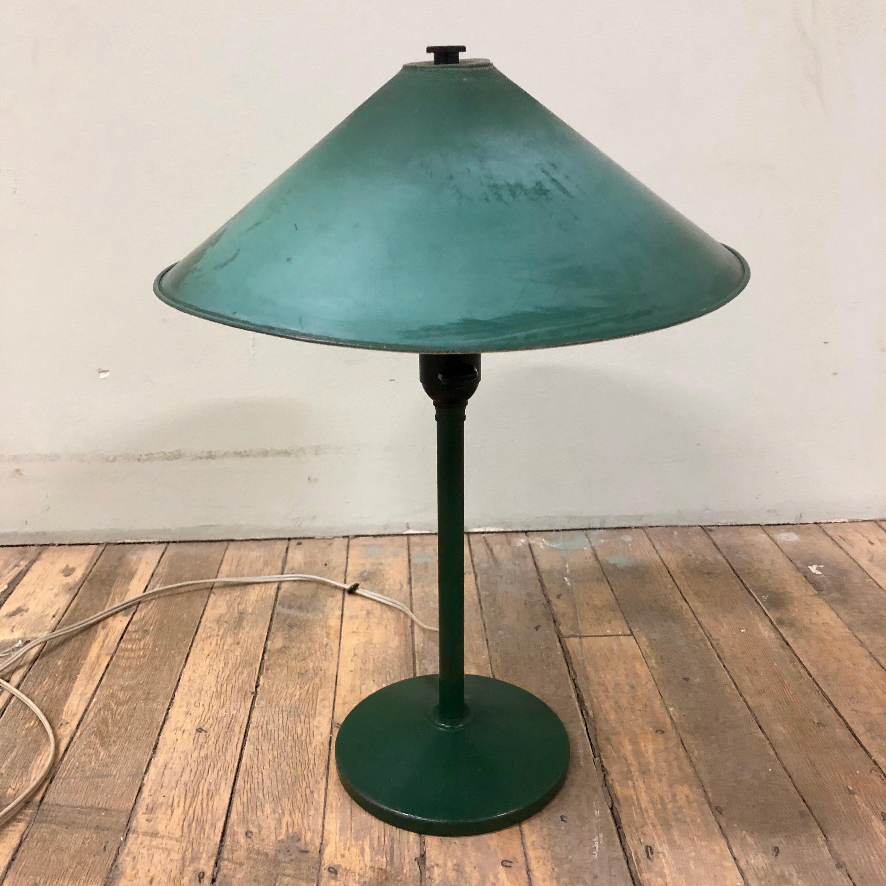 This classic table lamp has a forest green finish which exhibits a desirable patina. An individualist of a piece this lamp could add interest to any library or great room setting.

 