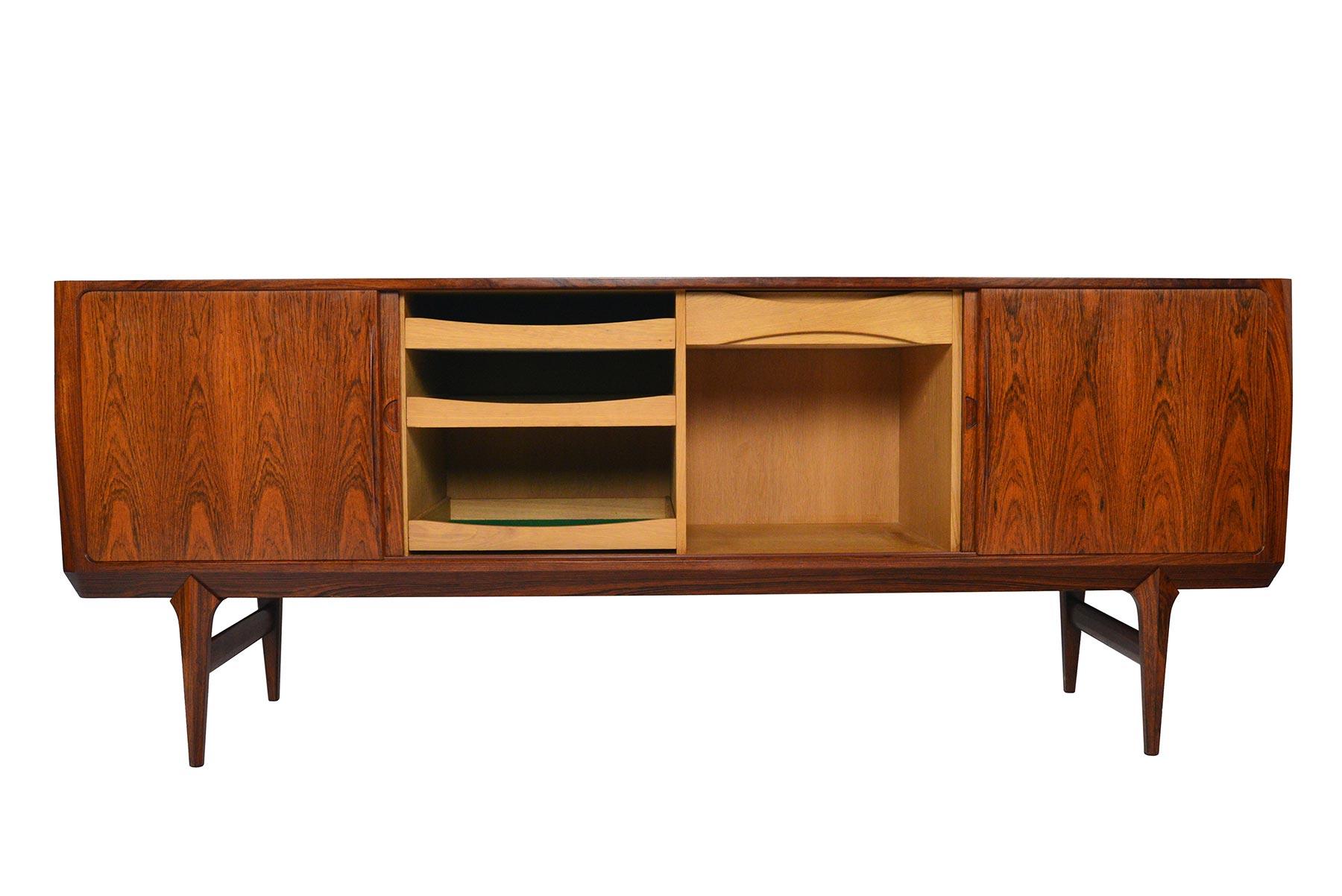 The genius is in the details with this magnificent Model 10 Danish modern sliding door credenza. Designed by Johannes Andersen for Hans Bech in 1961, and crafted in dramatic Brazilian rosewood, this rare design is unlike any other credenza that has