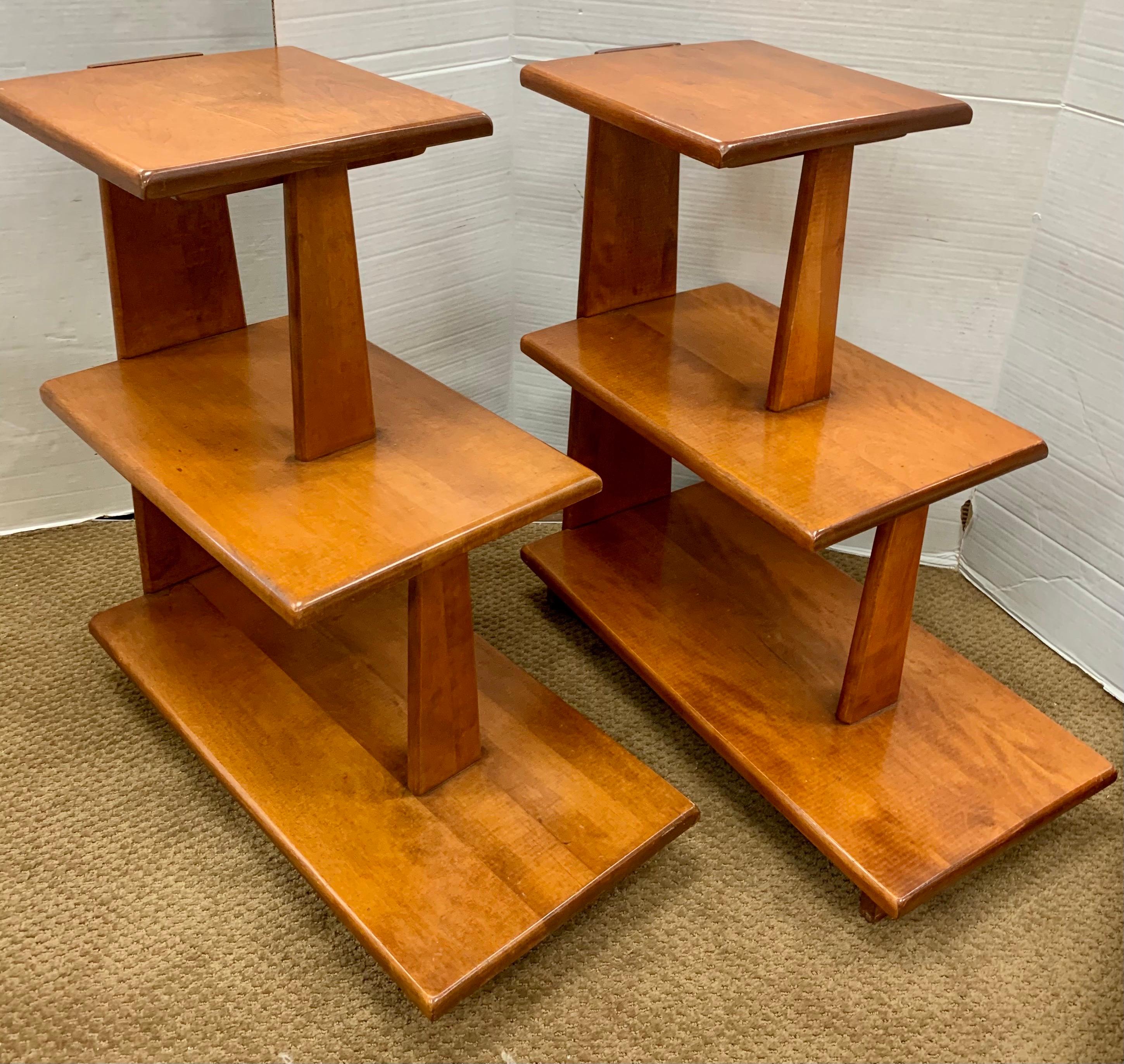 Accent your midcentury living space with these three tiered accent tables which offer displayable storage space.