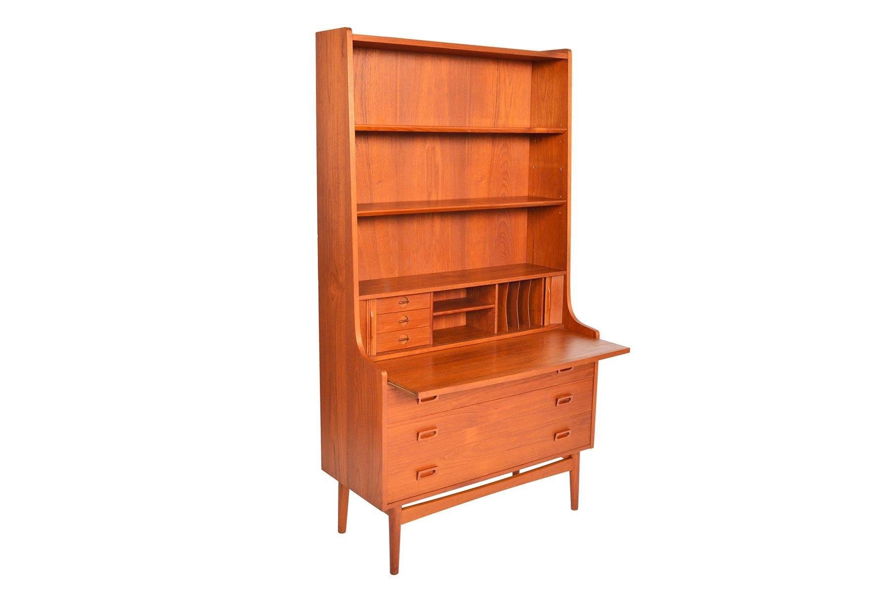This beautiful Danish modern midcentury bookcase in teak was designed by Johannes Sorth for Bornholm Møbelfabrik, Nexø. The tall, upper hutch features three adjustable shelves. The lower cabinet features three large drawers for plenty of storage. A