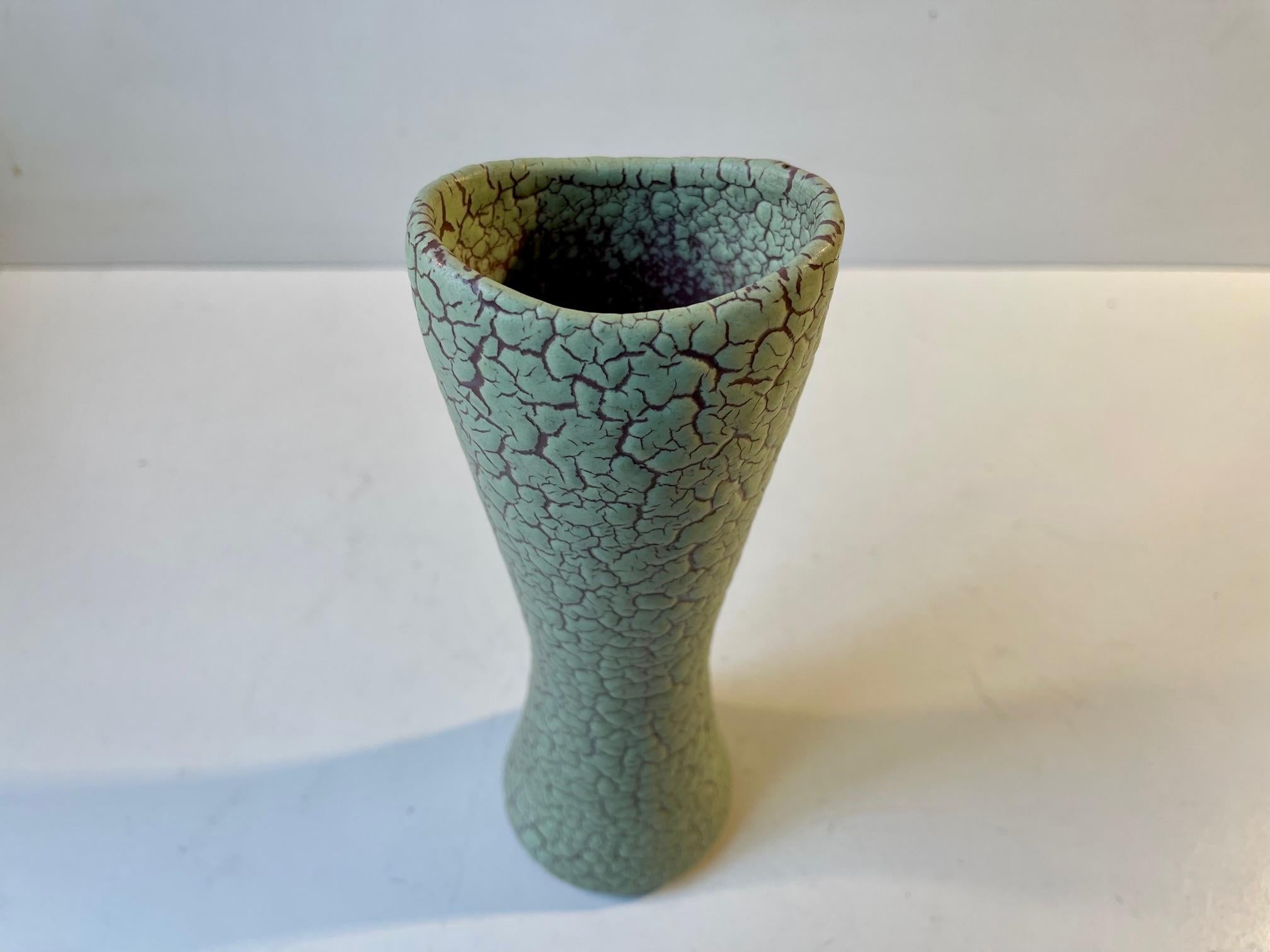 An hourglass shaped ceramic vase in delicately executed crackle glaze. Made and designed by Joska Keramik (1936-59) in Copenhagen Denmark circa 1950. Measurements: H: 21 cm, W/D: 8/6 cm.