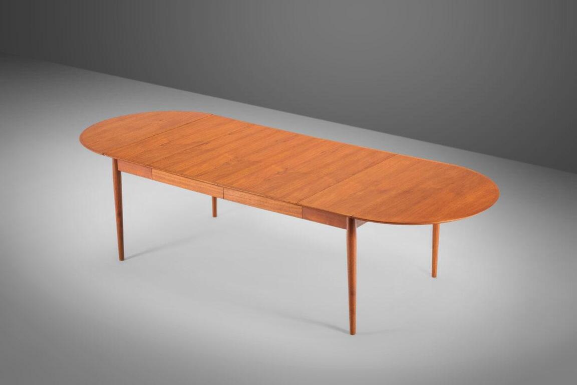An exceptional Minimalist midcentury Danish Modern teak extension dining table. Very versatile, with drop leaves and two extension leaves. By Arne Vodder for Sibast Møbler Denmark, circa 1960s.

---Dimensions---
Extended Width: 113.75 in / 288.93