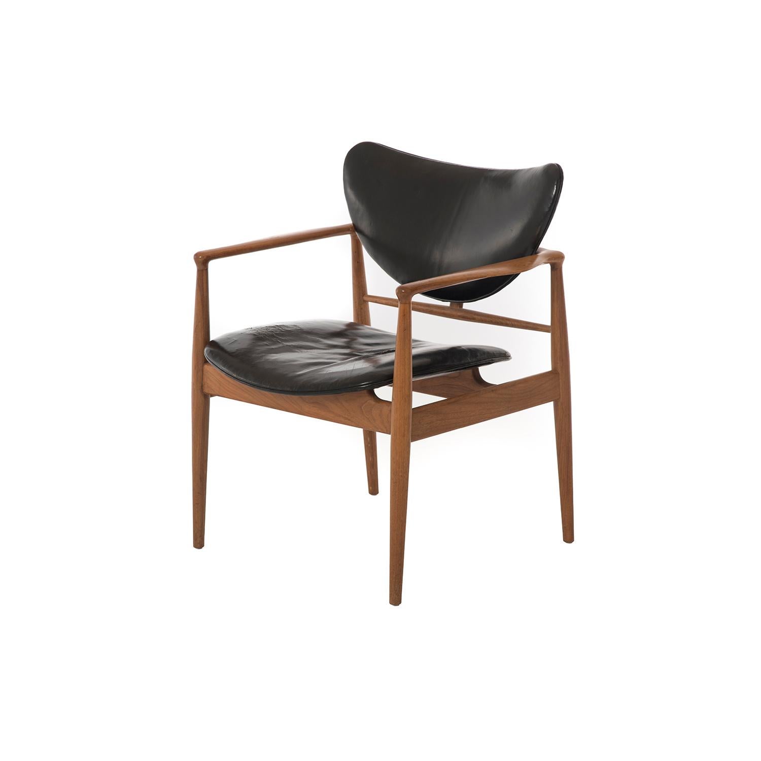 These classic Danish modern occasional lounges model 48 by Finn Juhl are crafted in walnut, by Baker Furniture. Sold with existing leather, which is in good condition but could be replaced. Frames are in lovely condition.