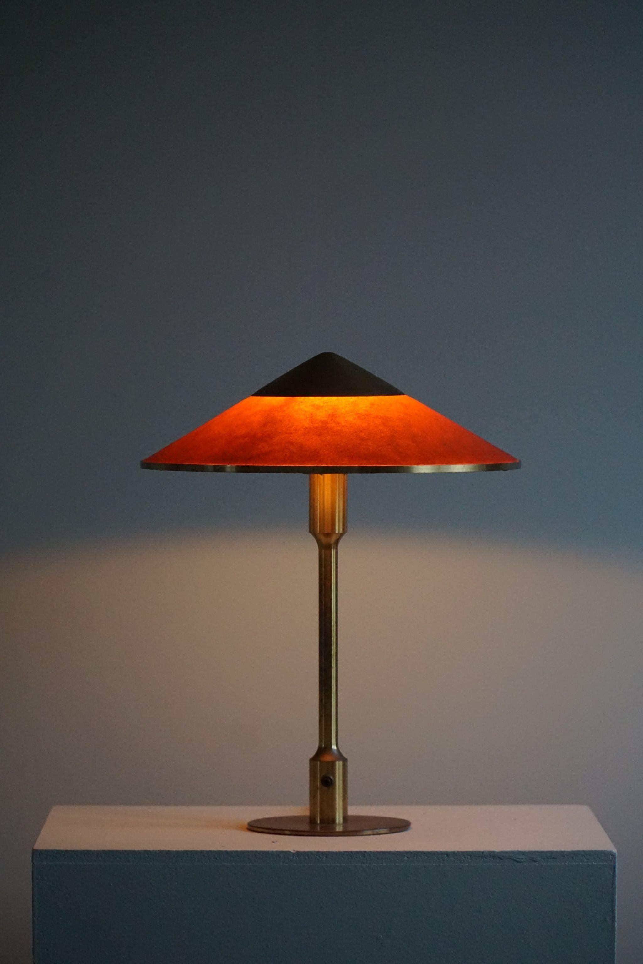 Rare table lamp by Niels Rasmusen Thykier, model ''T3” Major. Frame and top of brass, fabric in oil-impregnated red/orange paper screen. A first edition lamp from early production (1929) in its original condition. Manufactured by Thykier