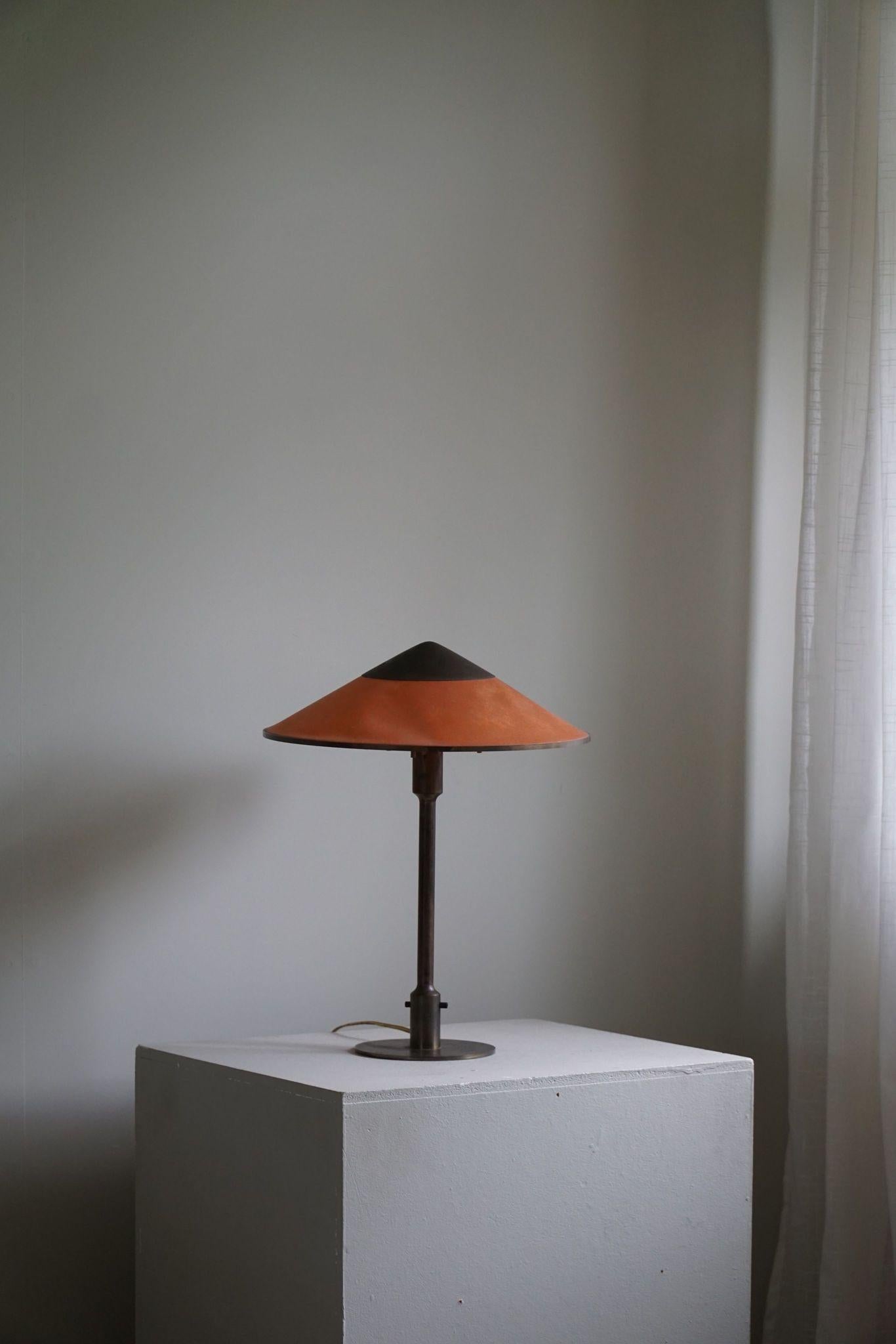 Rare table lamp by Niels Rasmusen Thykier, model ''T3” Major. Frame and top of brass, fabric in oil-impregnated red/orange paper screen. A first edition lamp from early production (1929) in its original condition. Manufactured by Thykier