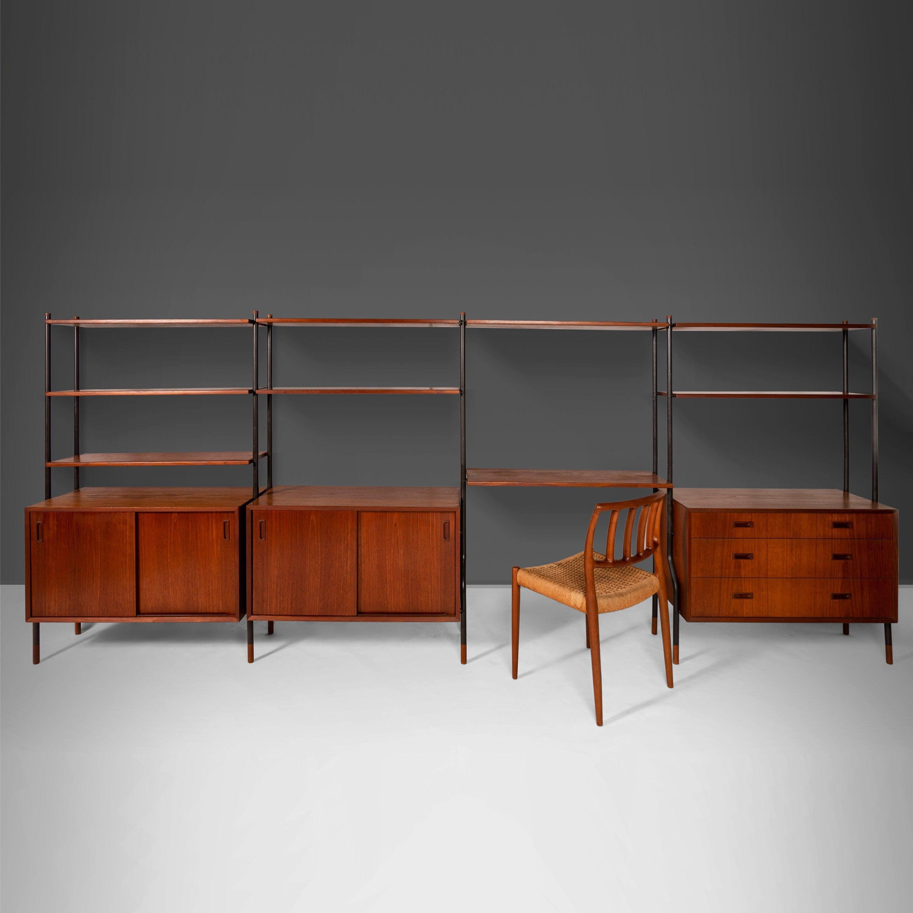 A rare find and truly an exceptional design is this wall unit by Lyby Mobler. The unit is assembled with steel poles, accented with teak caps. The unit can be adjusted to several configurations to best suit your space and/or daily use. The open