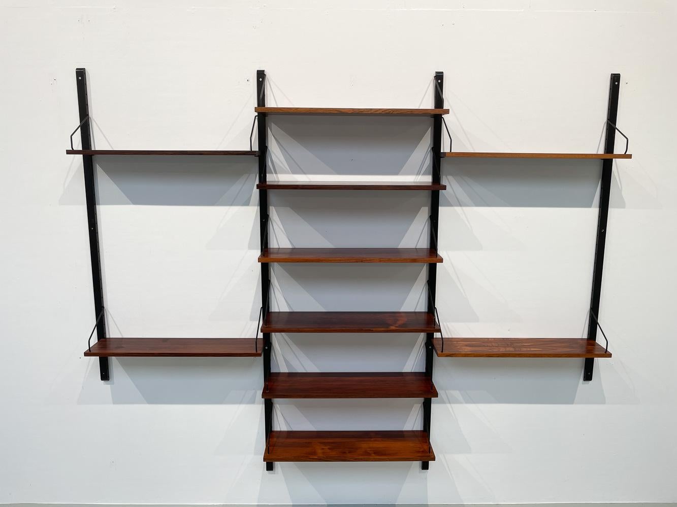 Vintage Danish rosewood wall unit by Poul Cadovius for Cado, 1960s.

Mid-Century Modern 3 bay shelving system model Royal. This is a original vintage floating bookcase designed in 1948 by Danish architect Poul Cadovius. 
Cadovius had the