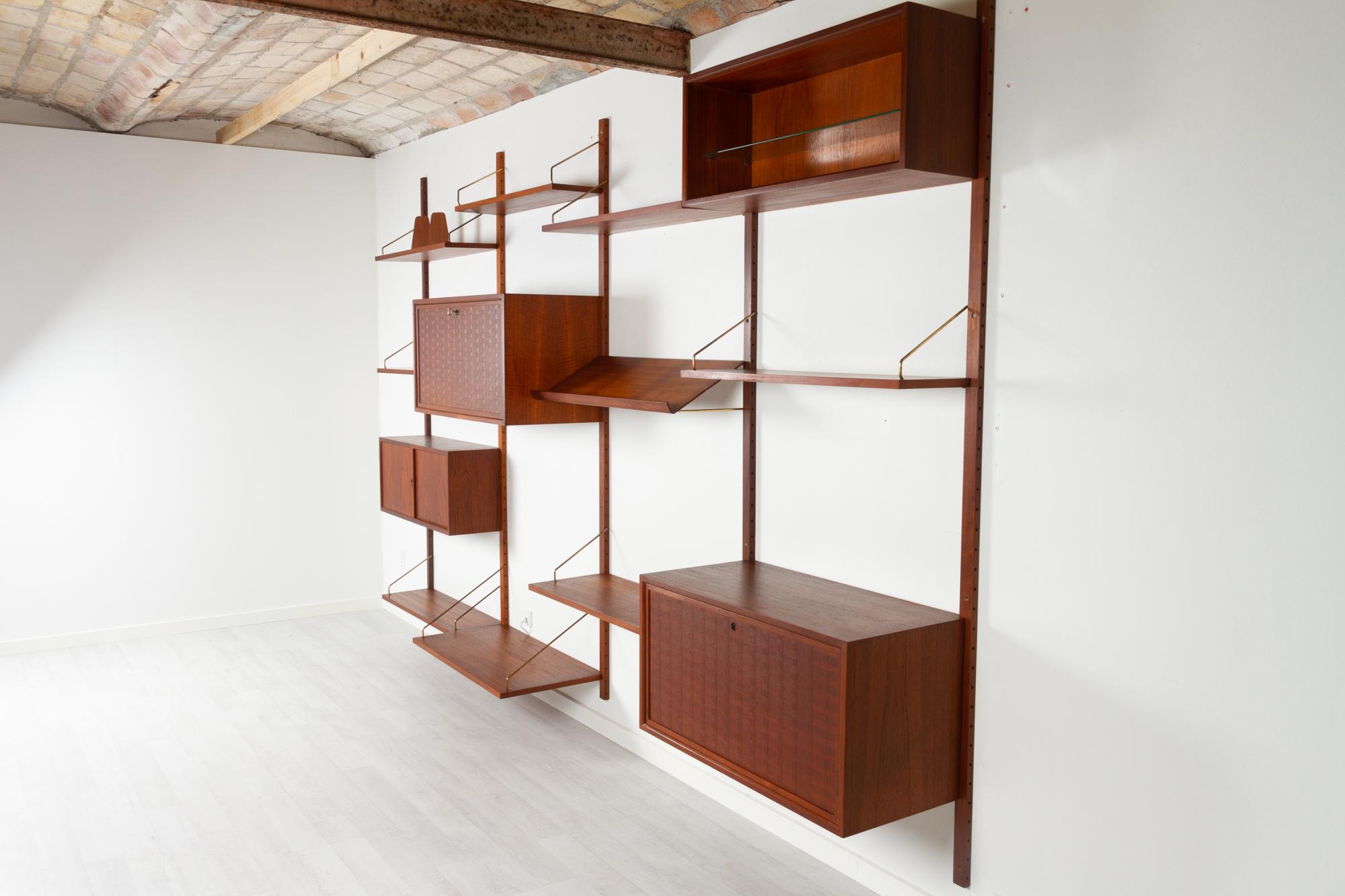 Vintage Danish teak wall unit by Poul Cadovius for Cado, 1950s.

Mid-Century Modern 4 bay shelving system model Royal. This is a original vintage shelving system designed in 1948 by Danish architect Poul Cadovius. 
Cadovius had the revolutionary