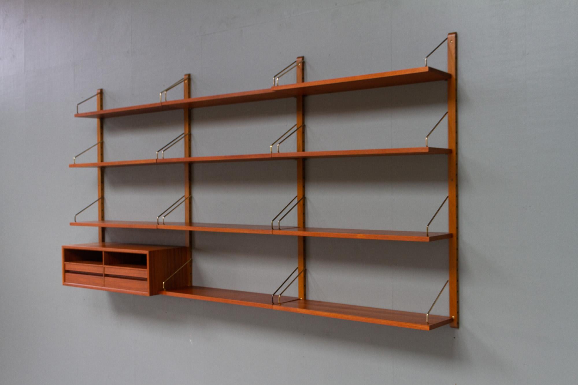 Vintage Danish teak wall unit by Poul Cadovius for Cado, 1950s.

Mid-Century Modern 3 bay shelving system model Royal. This is a original vintage floating bookcase designed in 1948 by Danish architect Poul Cadovius. 
Cadovius had the revolutionary