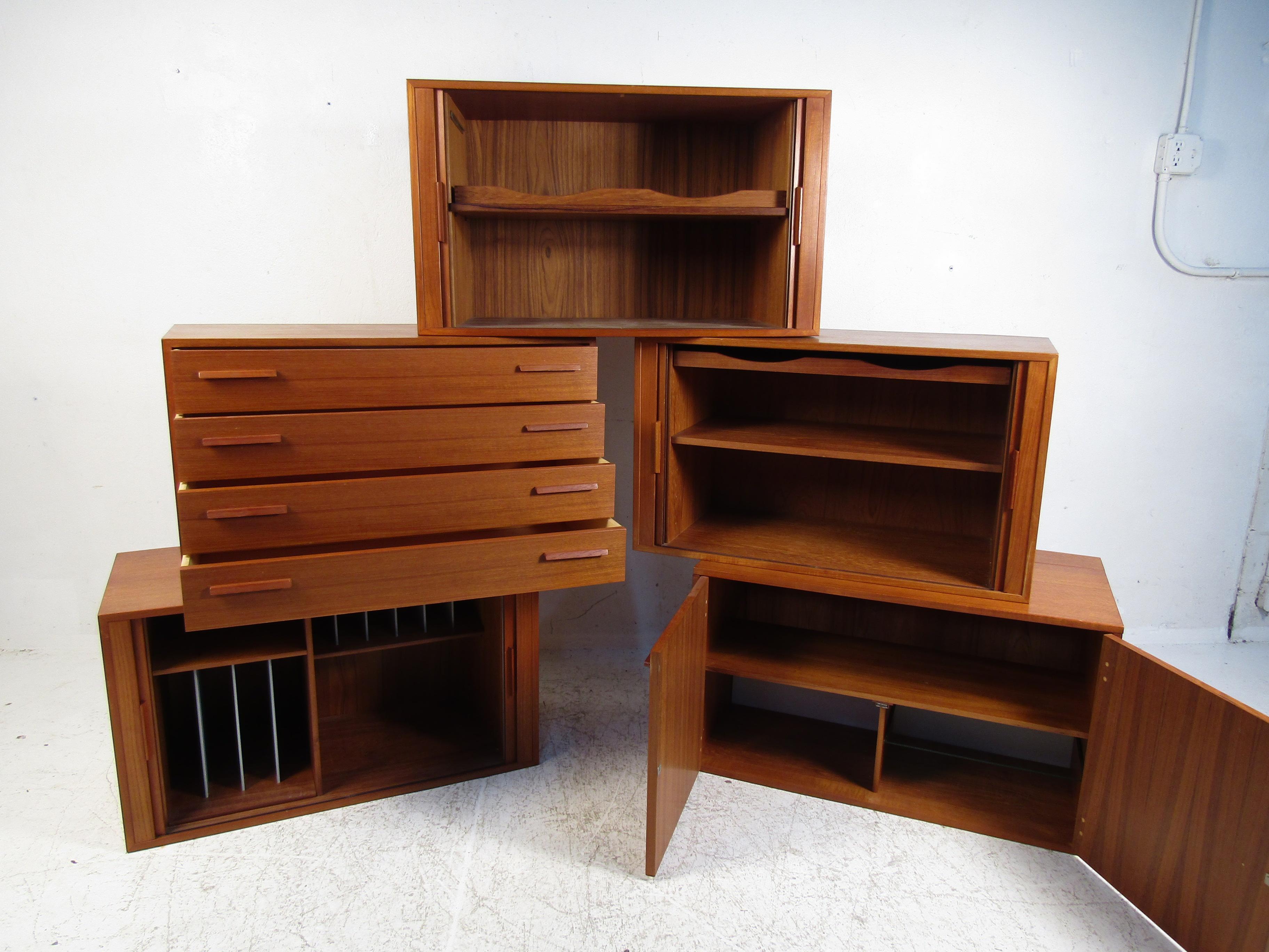 Unusual Danish modern wall-mounted cabinets. 5 pieces in total. Bracket mounts are on the backside of each cabinet. Can be set up in your home in a variety of ways. Please confirm item location with dealer (NJ or NY).
