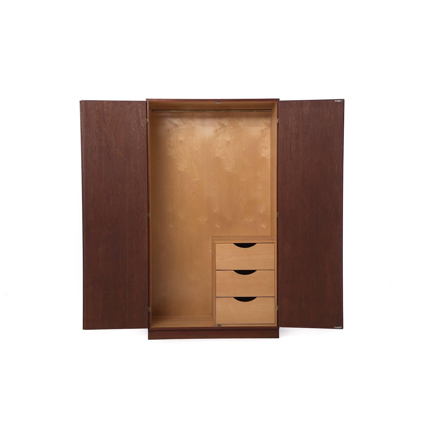 This Børge Mogensen wardrobe features an oiled teak exterior and a lacquered European beech wood interior. Hanger bar and three drawers with ledge provide storage and organization.