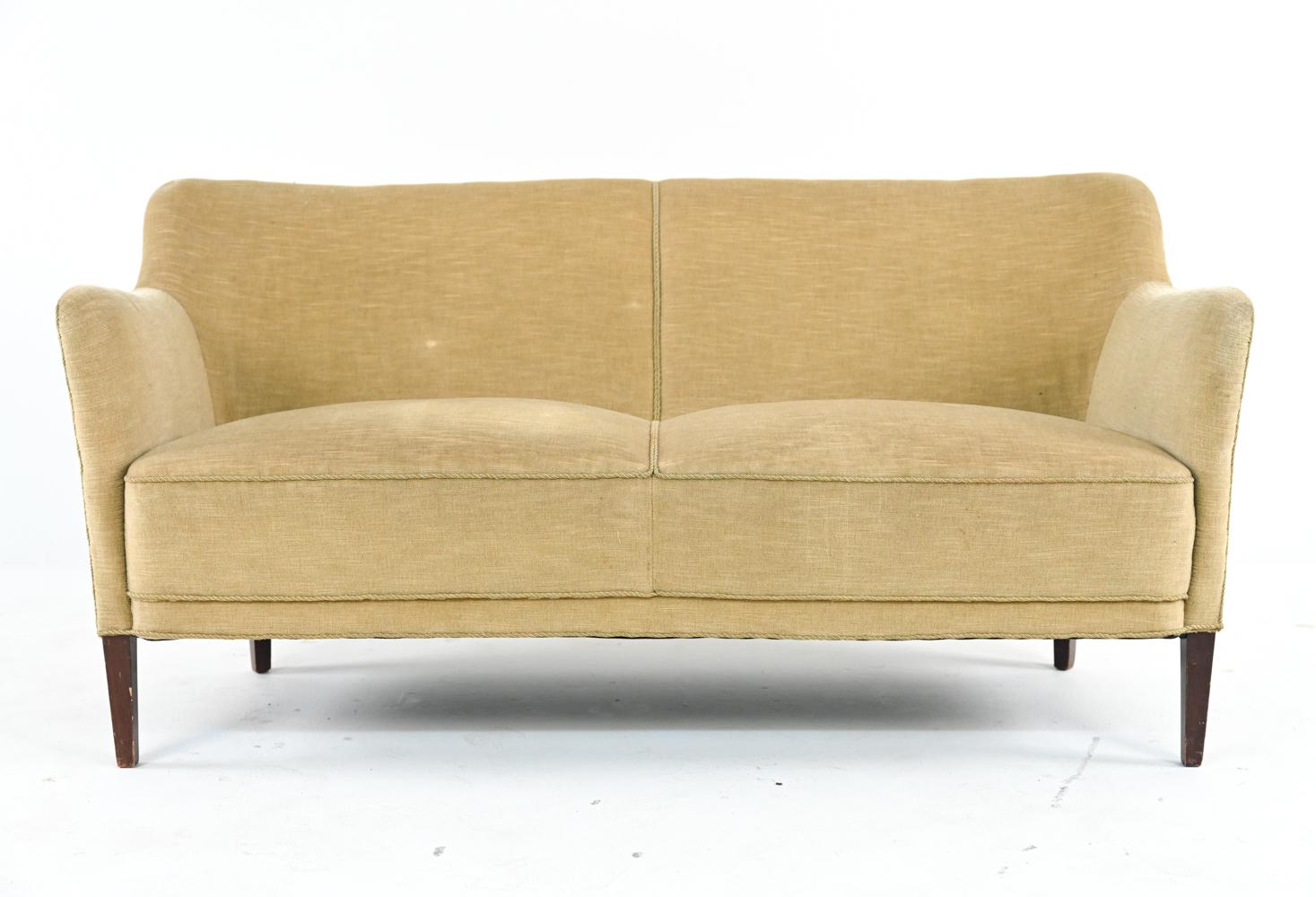 With its playful sculptural modern silhouette and chartreuse slubbed mohair chenille upholstery, this settee is like a breath of verdant spring air. Perched atop tapered legs of stained beechwood, this piece features a classic Danish bench seat and