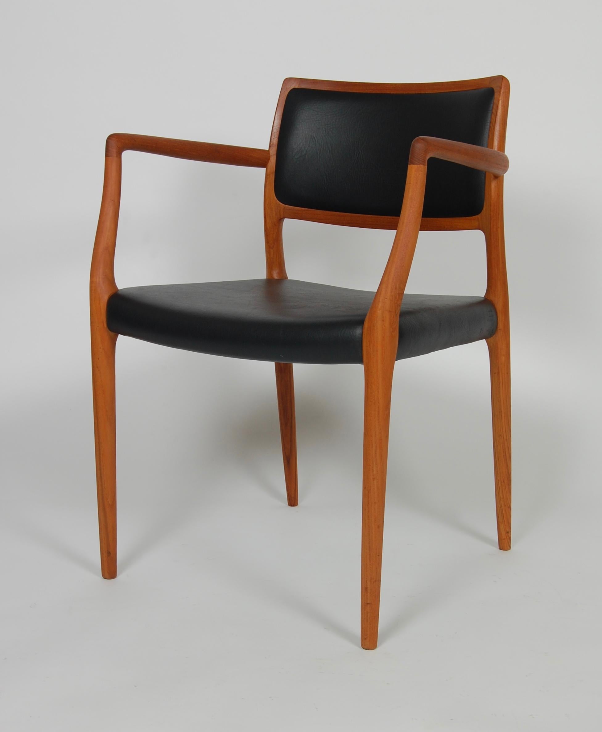 A simple and elegant design with wonderful ergonomics by designer Niels Moller, graceful and delicate lines to the teak frame, upholstered in heavy weight black leather.
