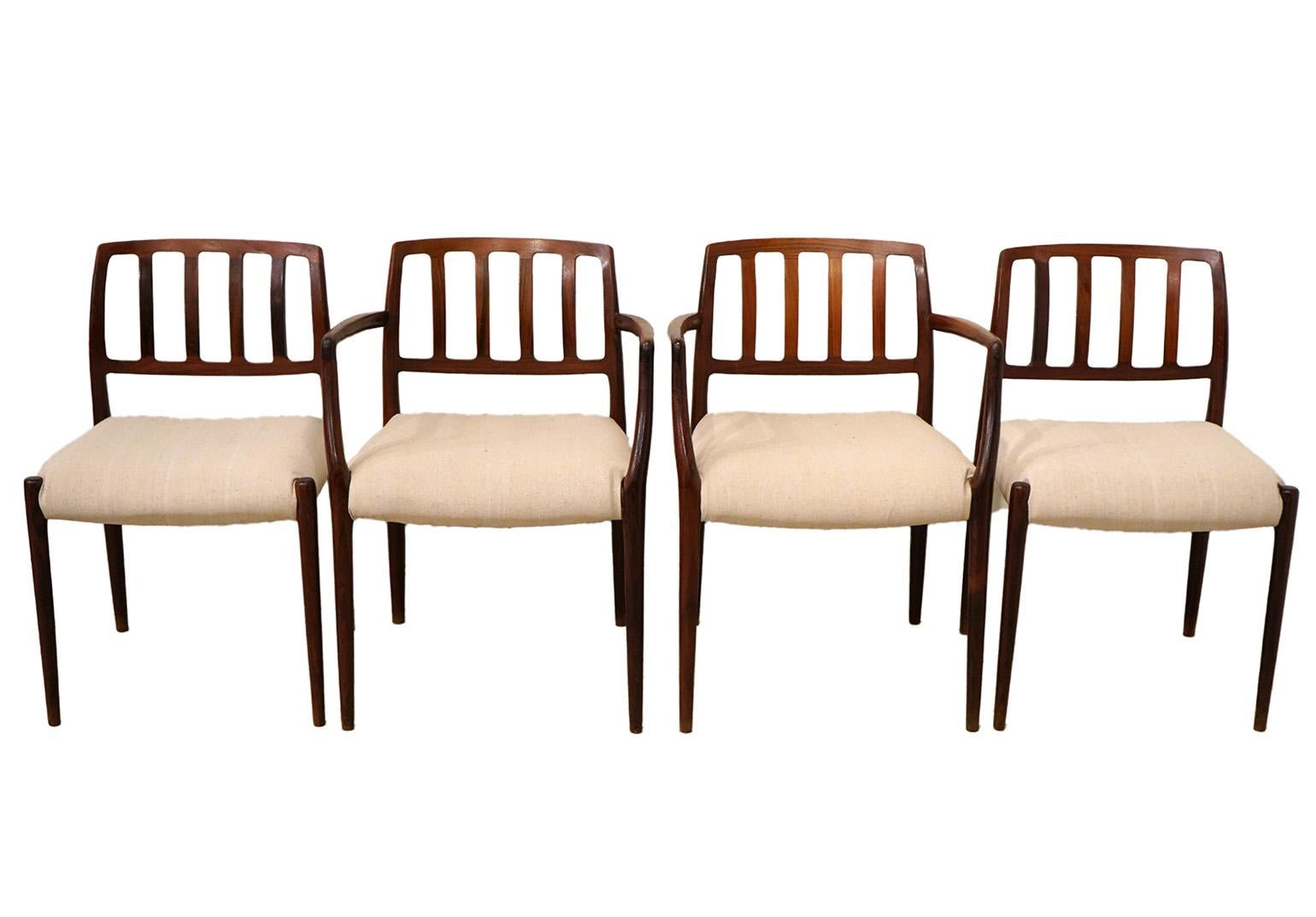 Set of 4 Niels Moller Dining chairs. Set includes 2 arm chairs and 2 side chairs. Newly upholstered and in good condition. 1970's Danish modern.
