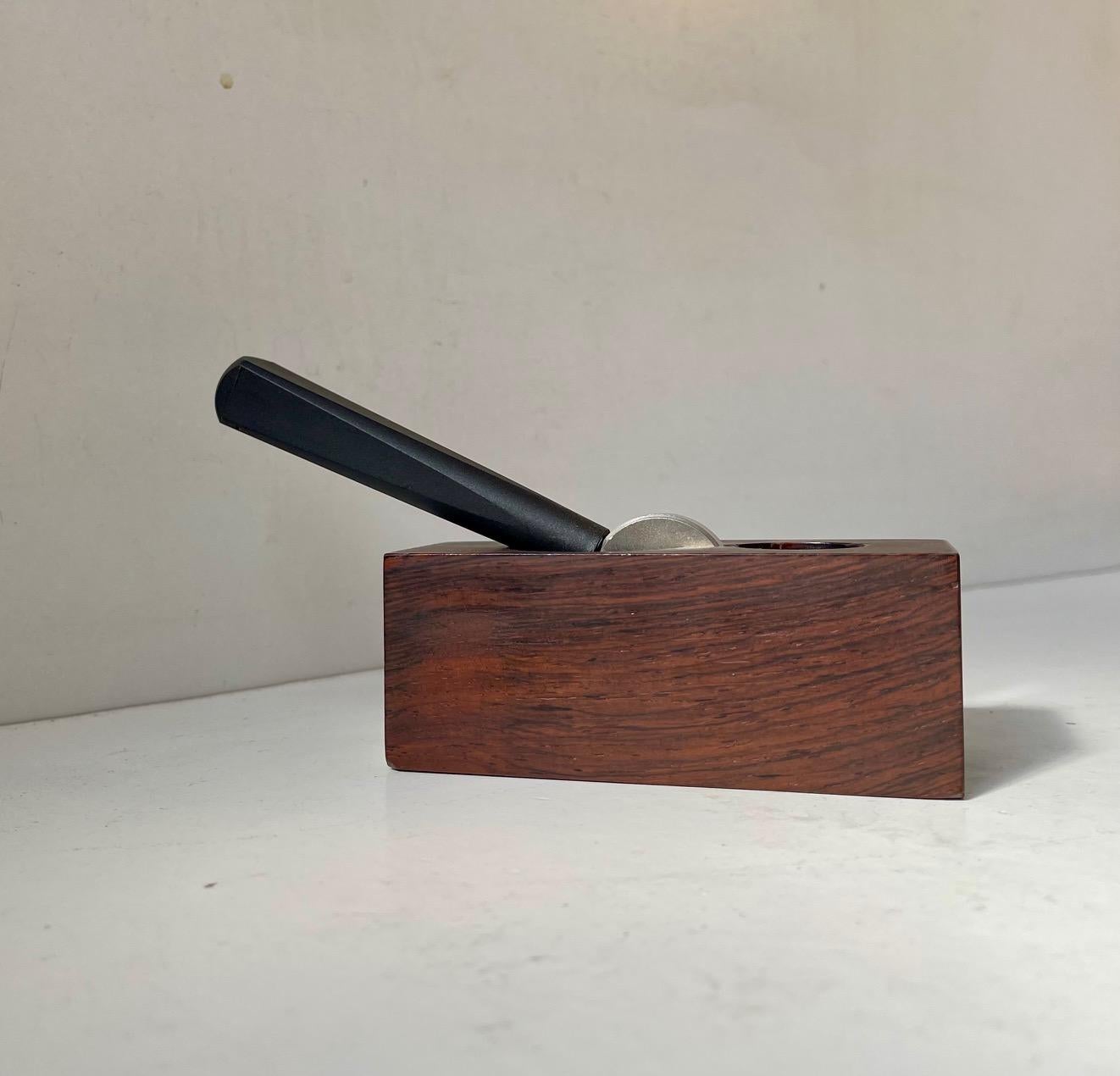 High quality, handmade and well-engineered nutcracker in rosewood, black resin and stainless steel. Designed and made by Yüksel Caglar in Denmark during the 1970s. It features two compartments. One for hazelnuts and one for walnuts. Please notice