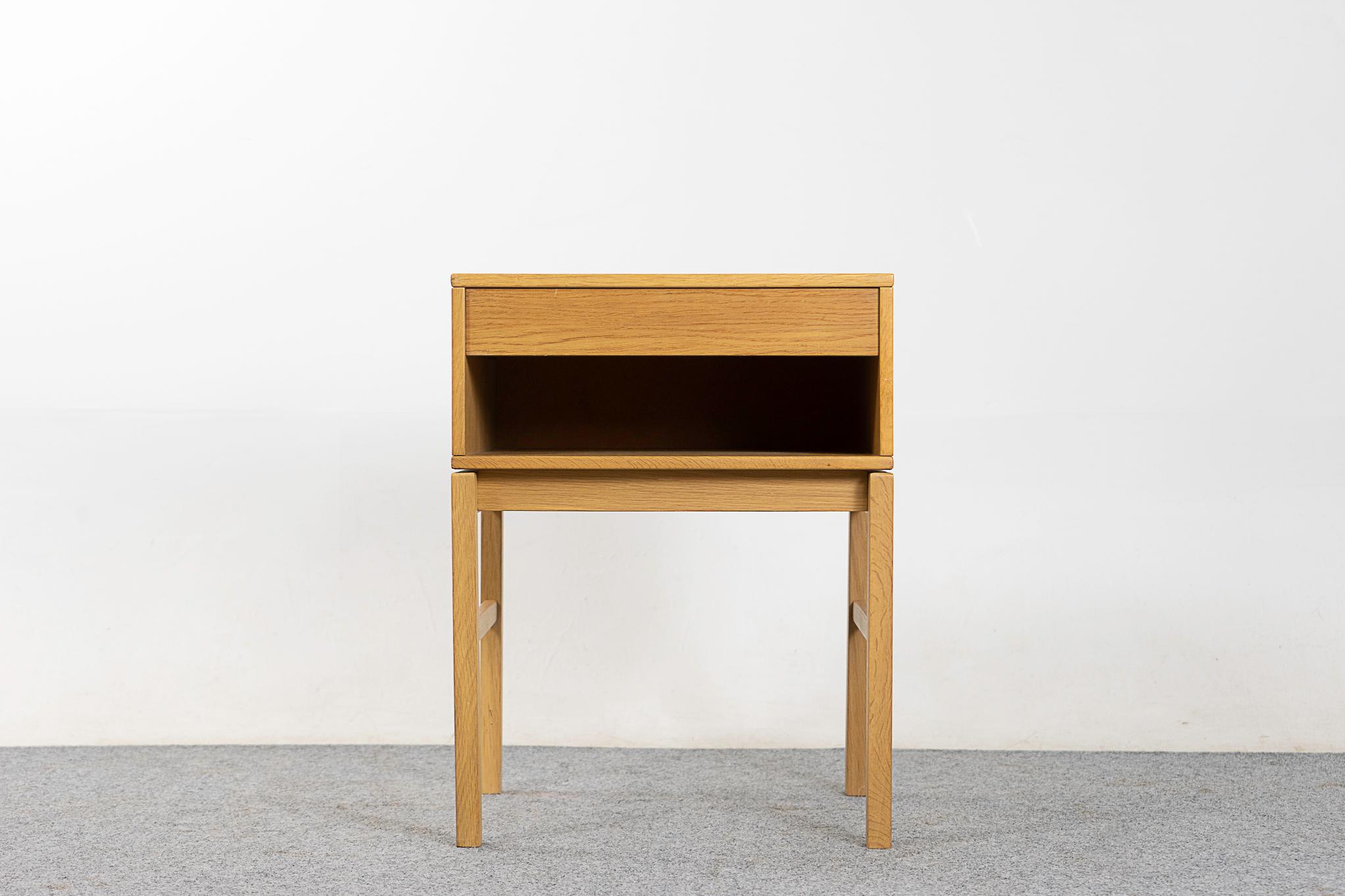 Oak Danish midcentury bedside table, circa 1970s. Dovetailed drawer for small items, an open cubby is perfect for your favorite book. A lovely basic essential.

Unrestored item, some marks consistent with age.

Please inquire for international