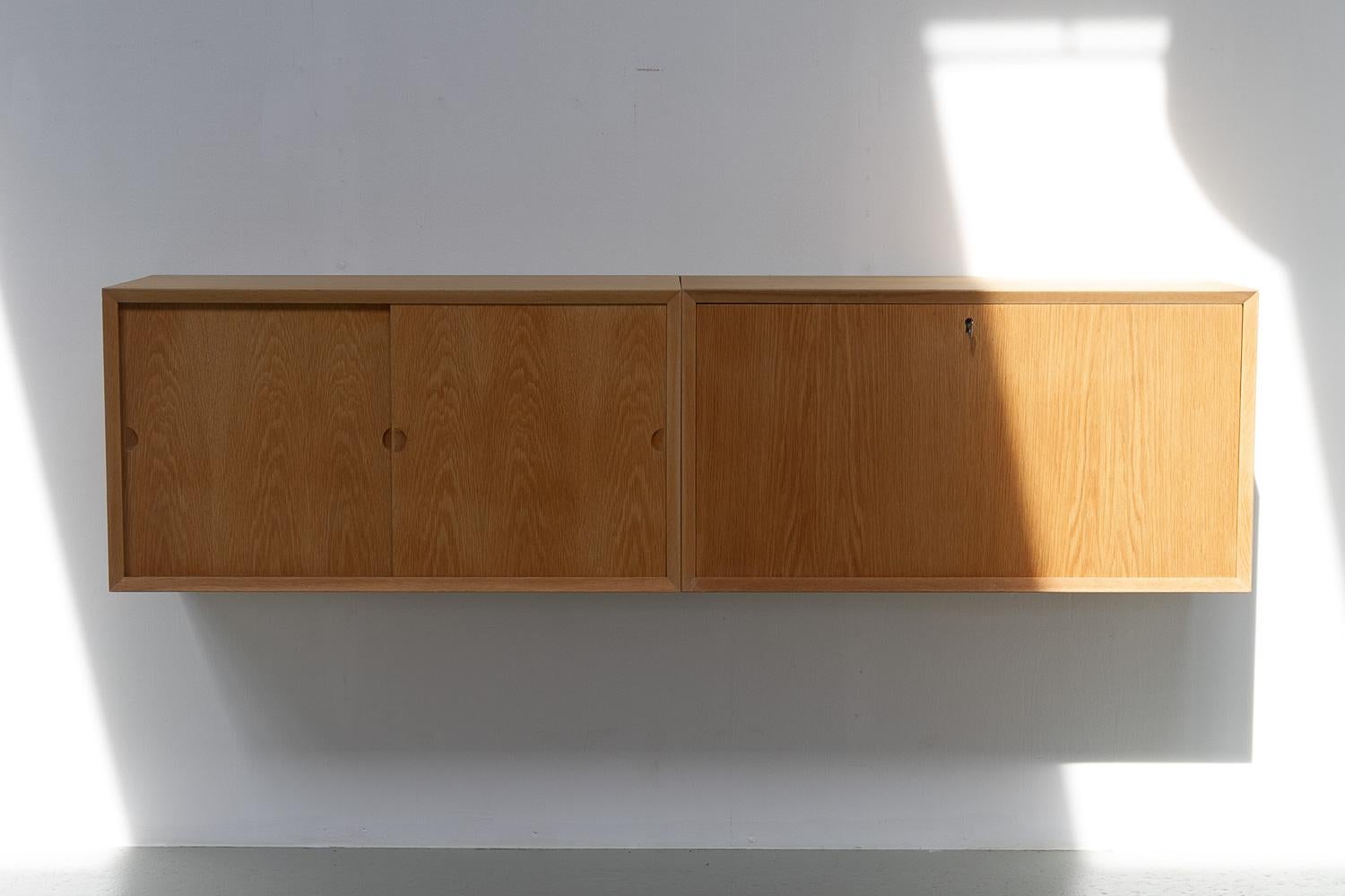 Danish Modern Oak Floating Sideboard by Poul Cadovius for Cado 1960s.

Scandinavian Mid-Century Modern 2 bay wall unit model Cado with back panels. This is a original vintage floating cabinets designed by Danish architect Poul Cadovius. 
Cadovius