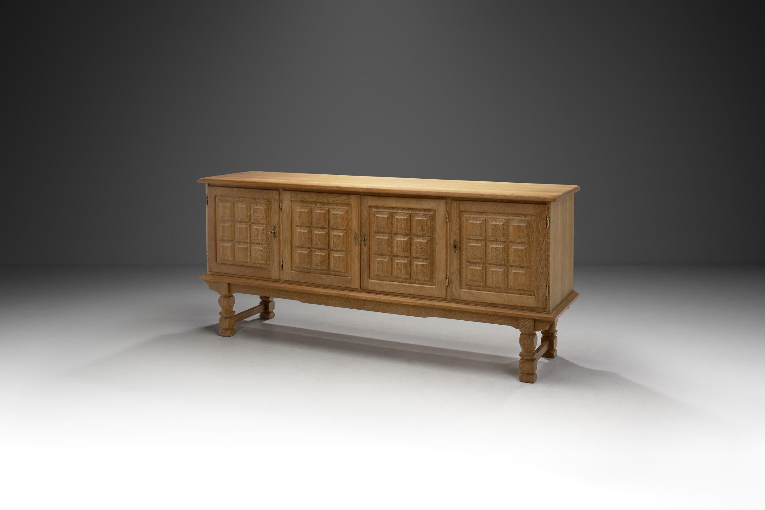 Reminiscent of Danish designer Henning Kjærnulf’s signature style, this grandiose sideboard melds seamlessly with any interior thanks to its elegant proportions and refined use of materials. The oak form is elemental, with the look enhanced by the
