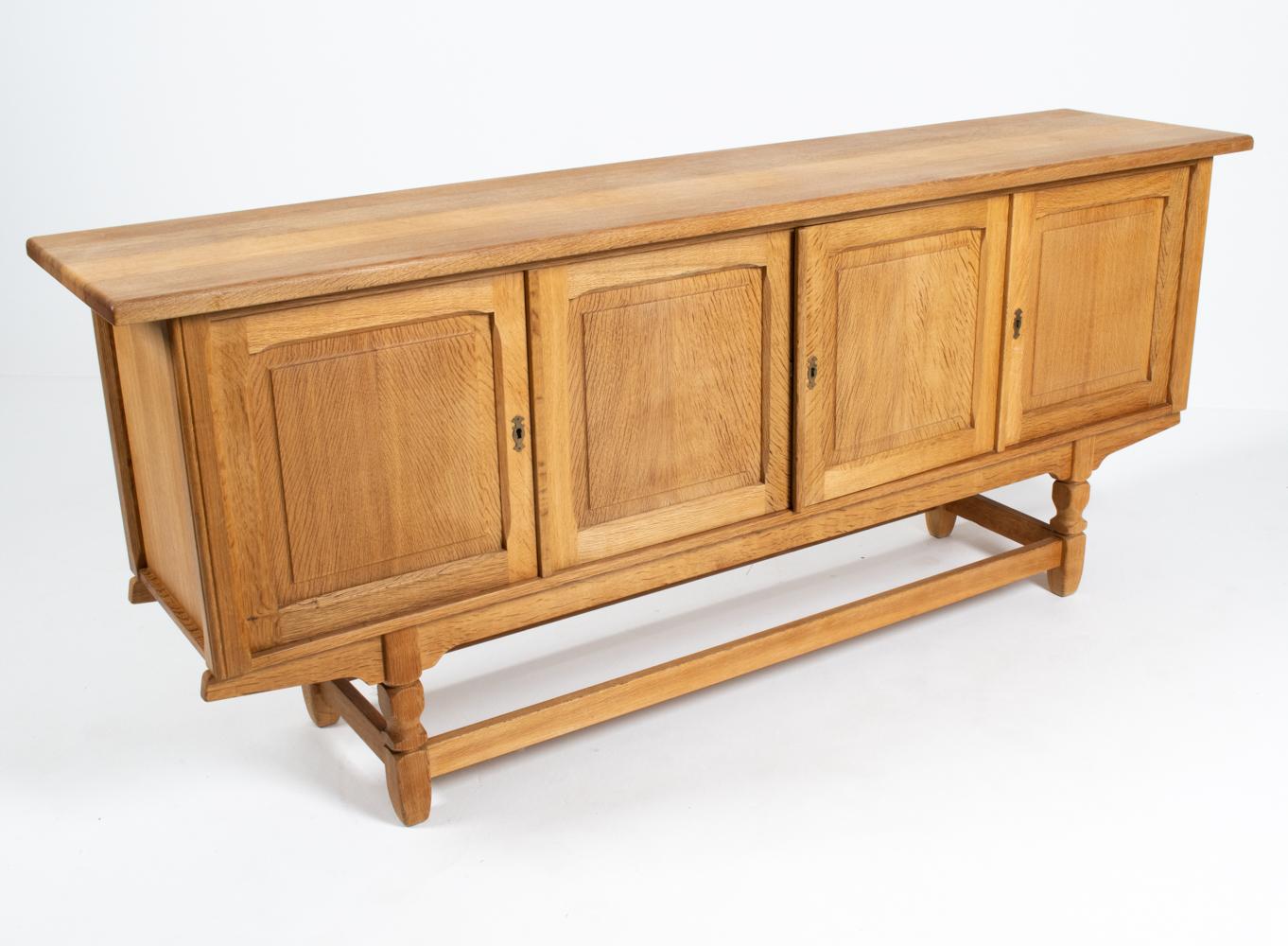 The natural beauty of quarter-sawn white oak takes center stage in this exceptional sideboard cabinet. Sturdy and solid, this piece features craftsman details including dovetailed drawers, recessed panel doors with interesting chamfered molding, and