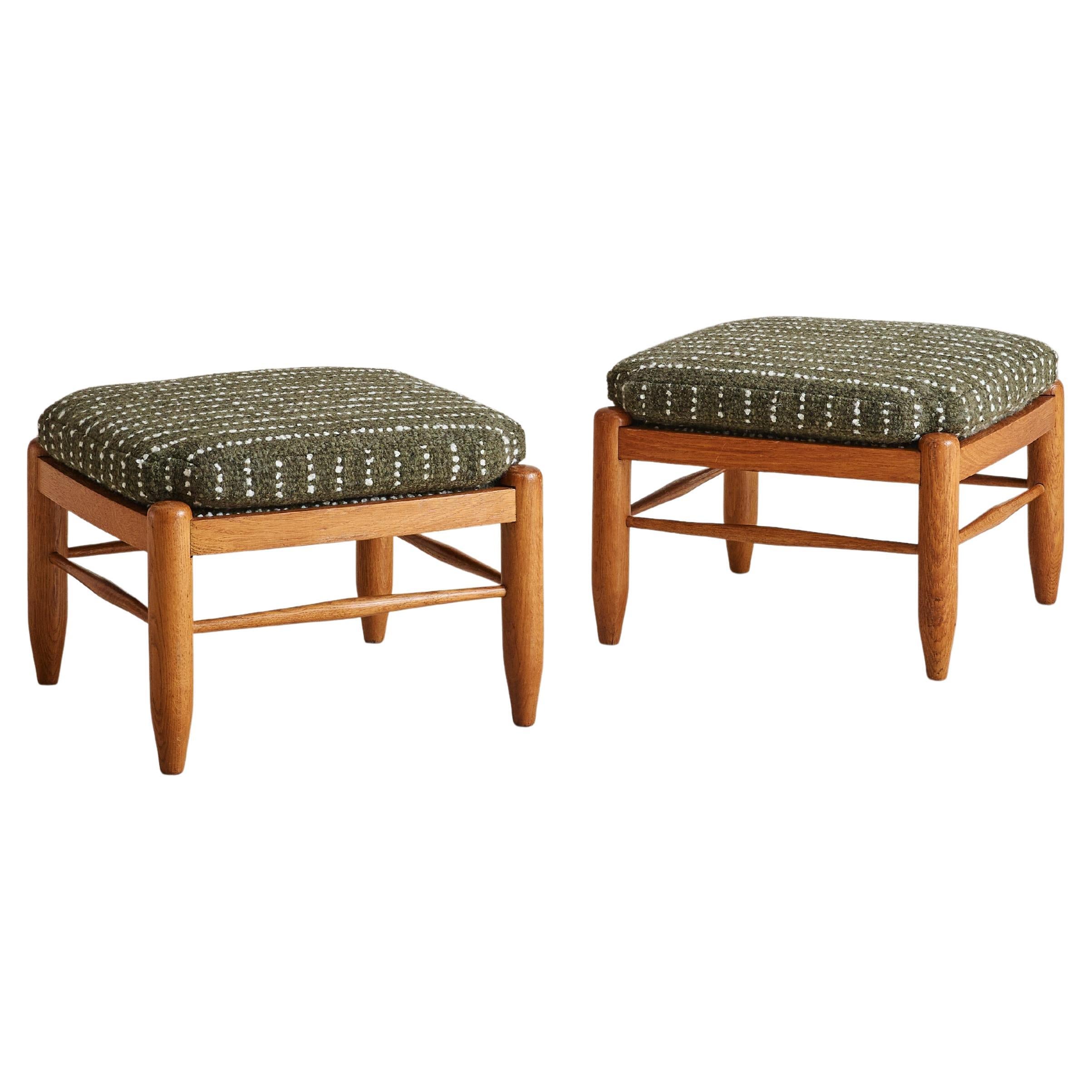 Sold and priced individually.

A 1960s Danish Modern low stool crafted from solid oak, featuring softly rounded edges and tapered legs. Reupholstered in forest-green wool with a textured weave, it serves as versatile seating or an accent piece that