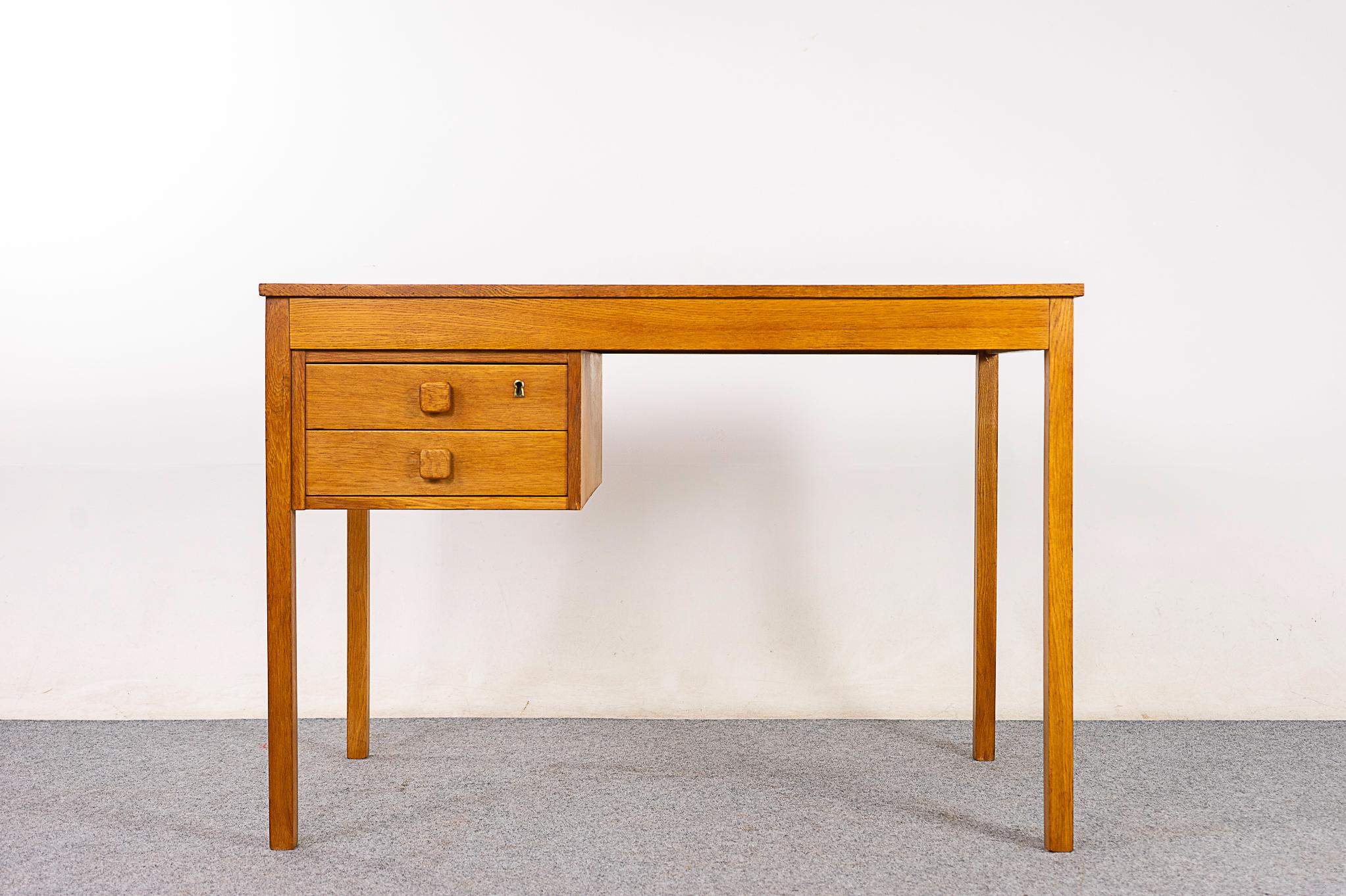 Oak mid-century desk circa 1960's. Small scale, perfect for the home office or kids room! Finished on both sides, looks fantastic from every angle. Beautiful wax finish keeps the wood tone looking very natural!