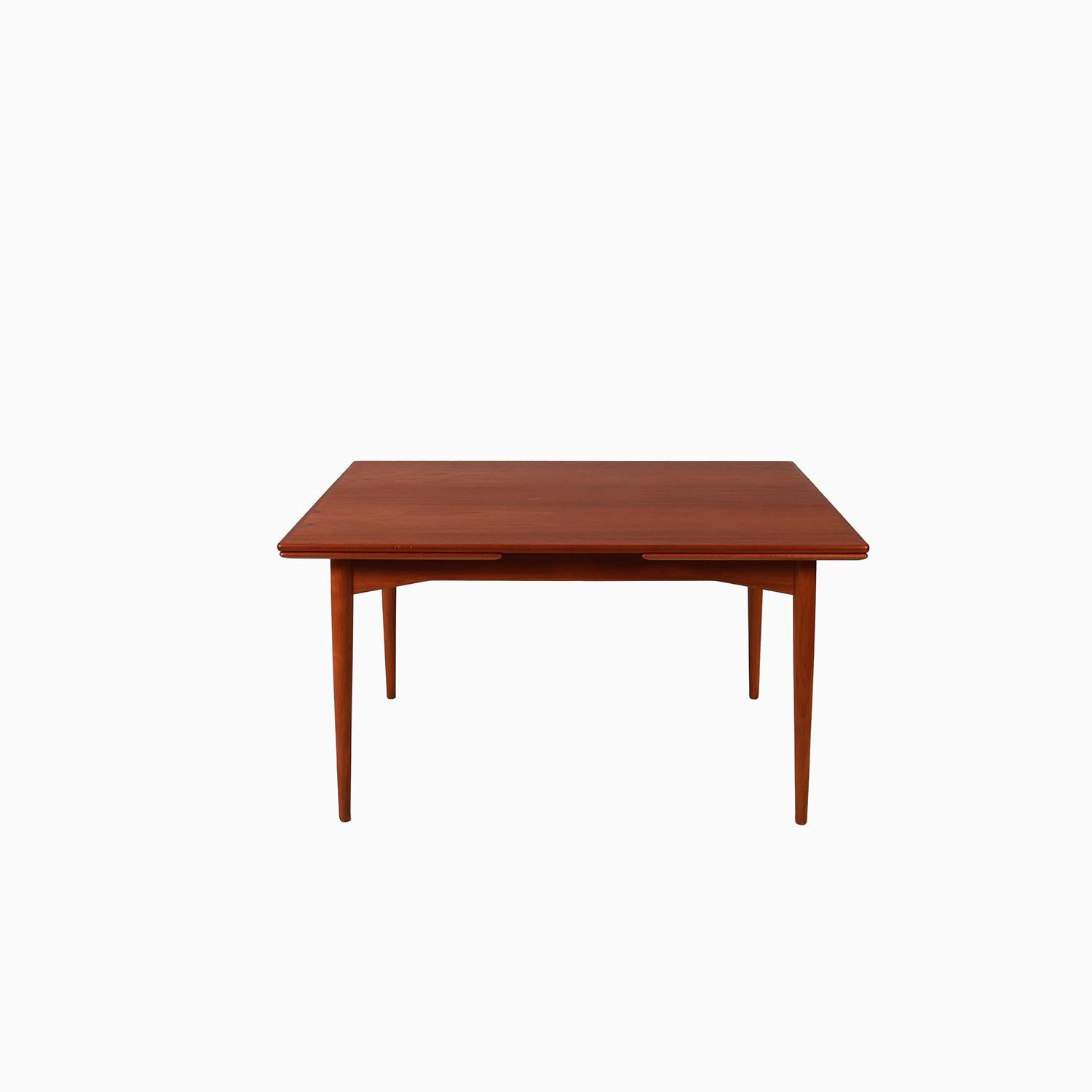 A Danish Modern extension table designed by Omann Jun. Exceptional details and quality. Beautiful book matched teak and a subtle angular apron. Restored condition.

Professional, skilled furniture restoration is an integral part of what we do every