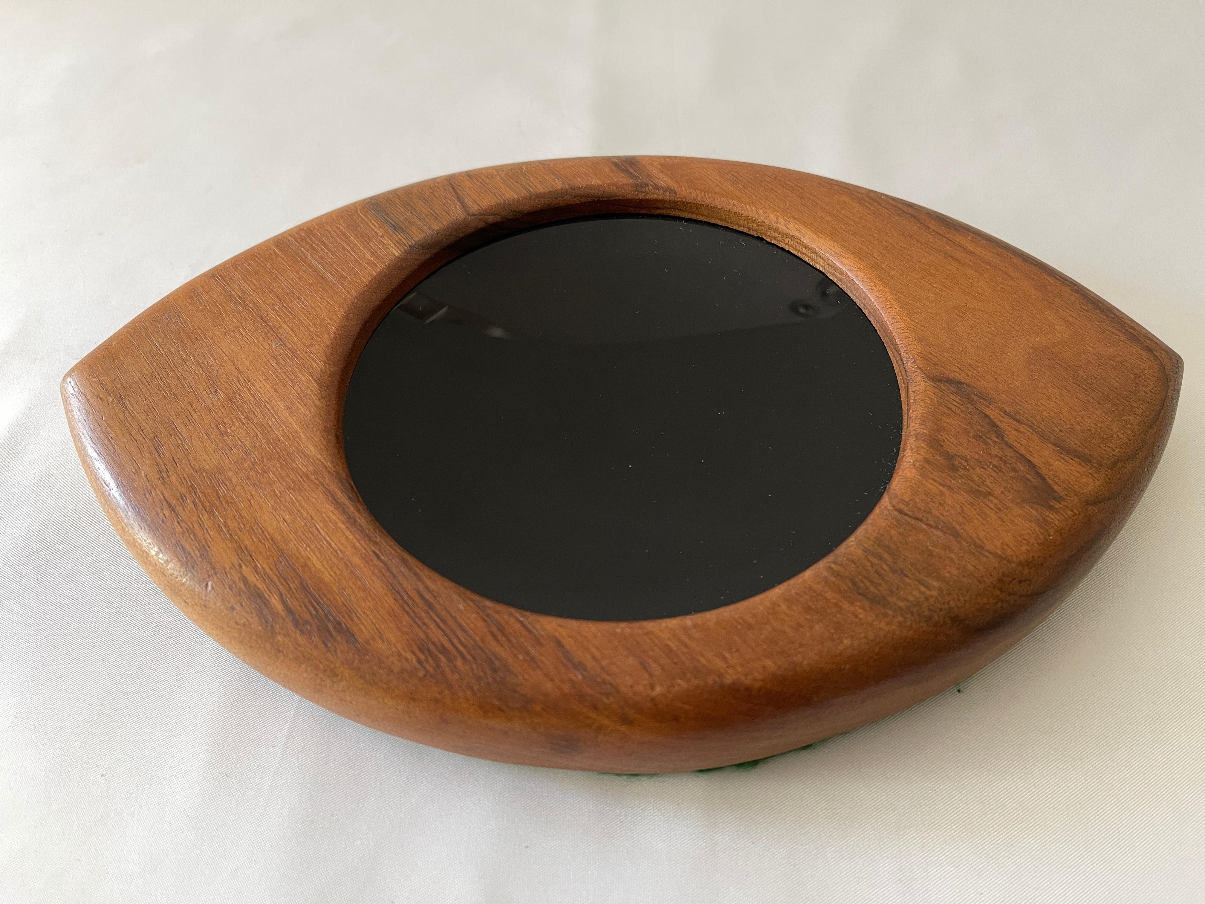 Danish modern eye shape Op Art teak wood dresser tray with black convex lucite center, and felt covered bottom. Convex lucite center measures 4.75