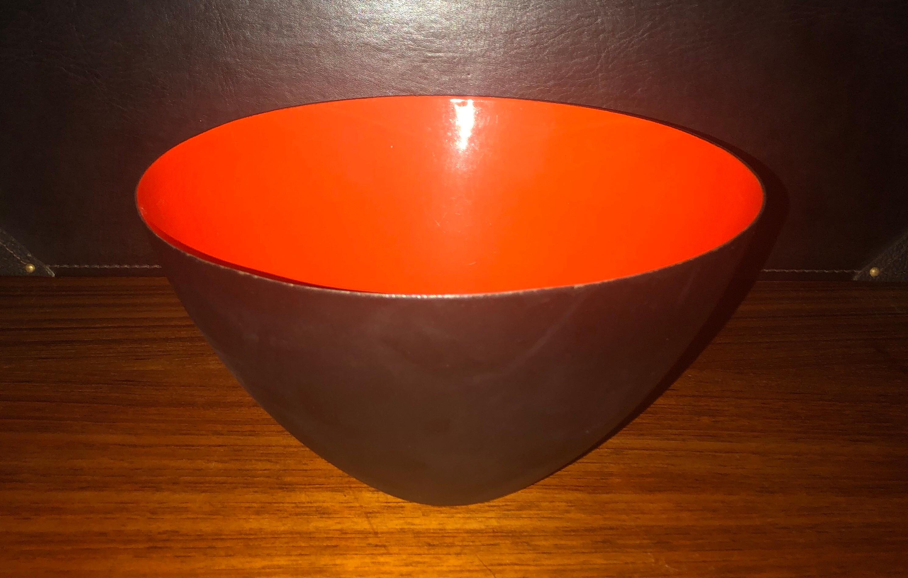 Danish modern orange / black enamel Krenit bowl by Herbert Krenchel for Torben Orskov, circa 1950s. Beautiful color and condition on this vintage piece with no chips to the enamel, but some minor wear on the outside of the bowl. Signed on the