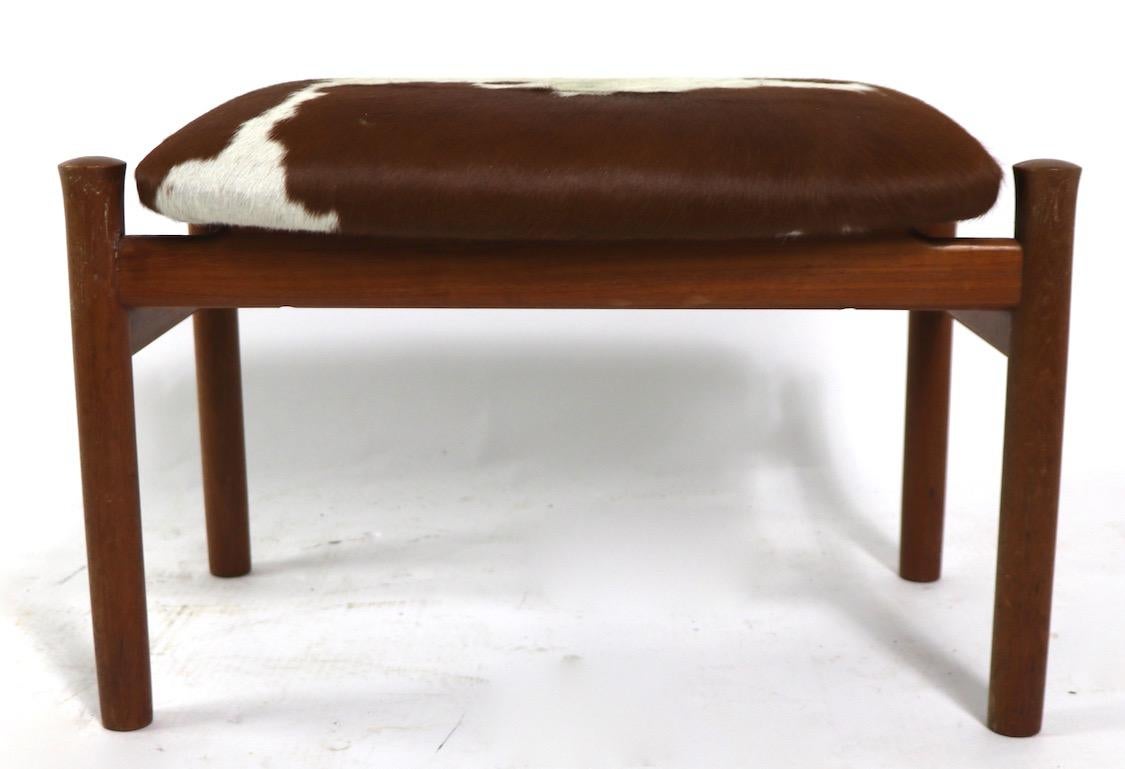 Classic Danish Modern stool, designed by Soren Hansen for Fritz Hansen, circa 1960s. Teak structure with newly upholstered in cowhide. Clean and ready to use condition.