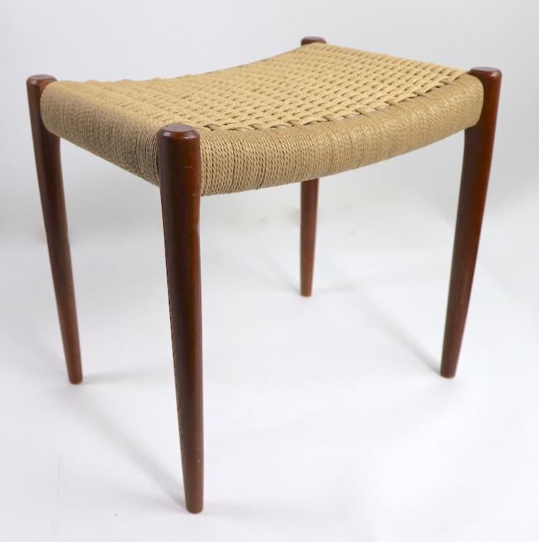 Classic Danish modern ottoman, footstool, by J.L. Moller in teak with paper cord seat (Model 80A circa 1960s). This example is in very fine condition, clean and ready to use.