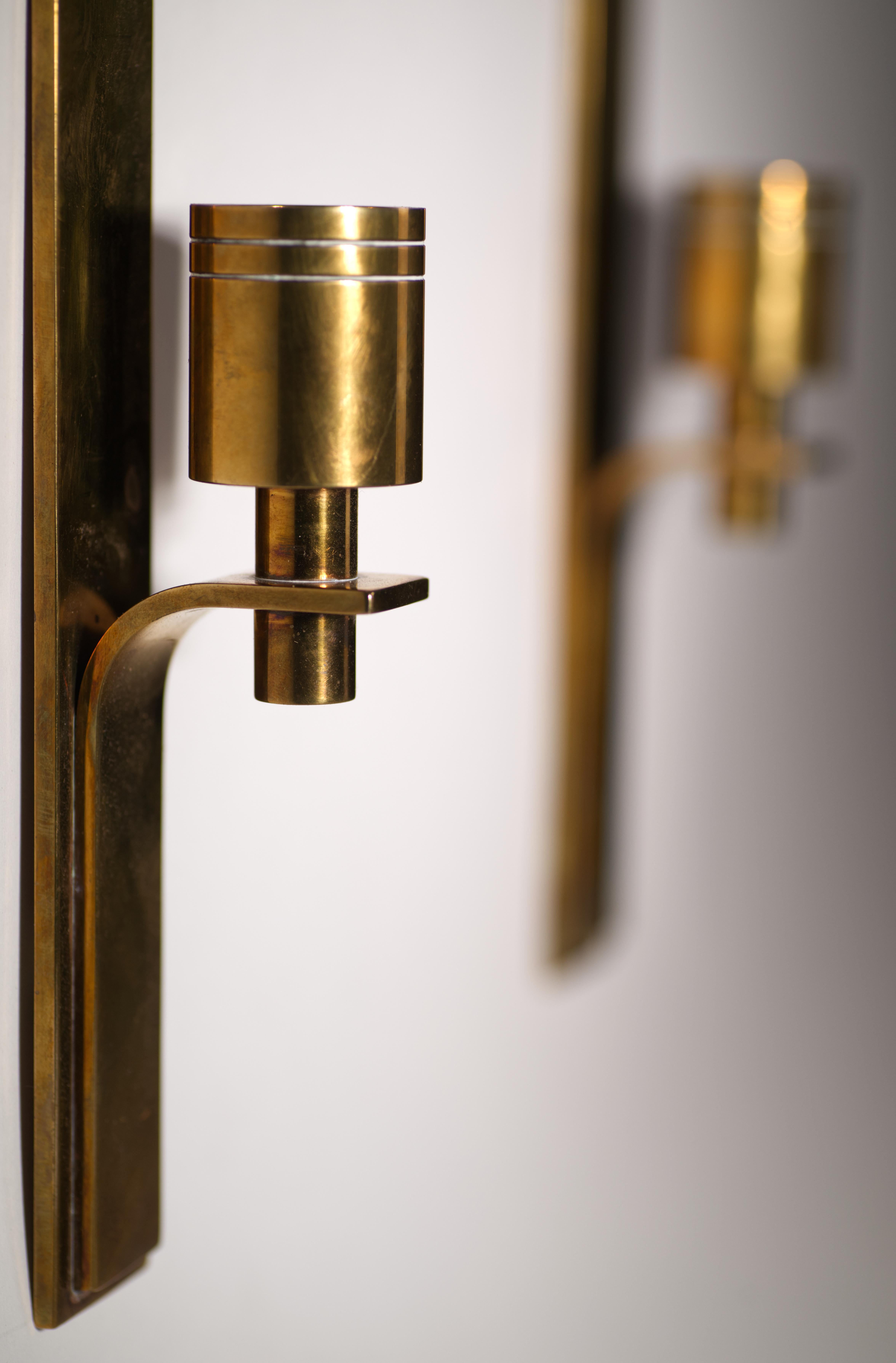  Vintage sculptural pair of wall-mounted candleholders are a fine example of Scandinavian Mid-Century Modern design.

The sconces are in good vintage condition with rich, warm, age-appropriate patina; they are well-made and heavy, with wall-mounted