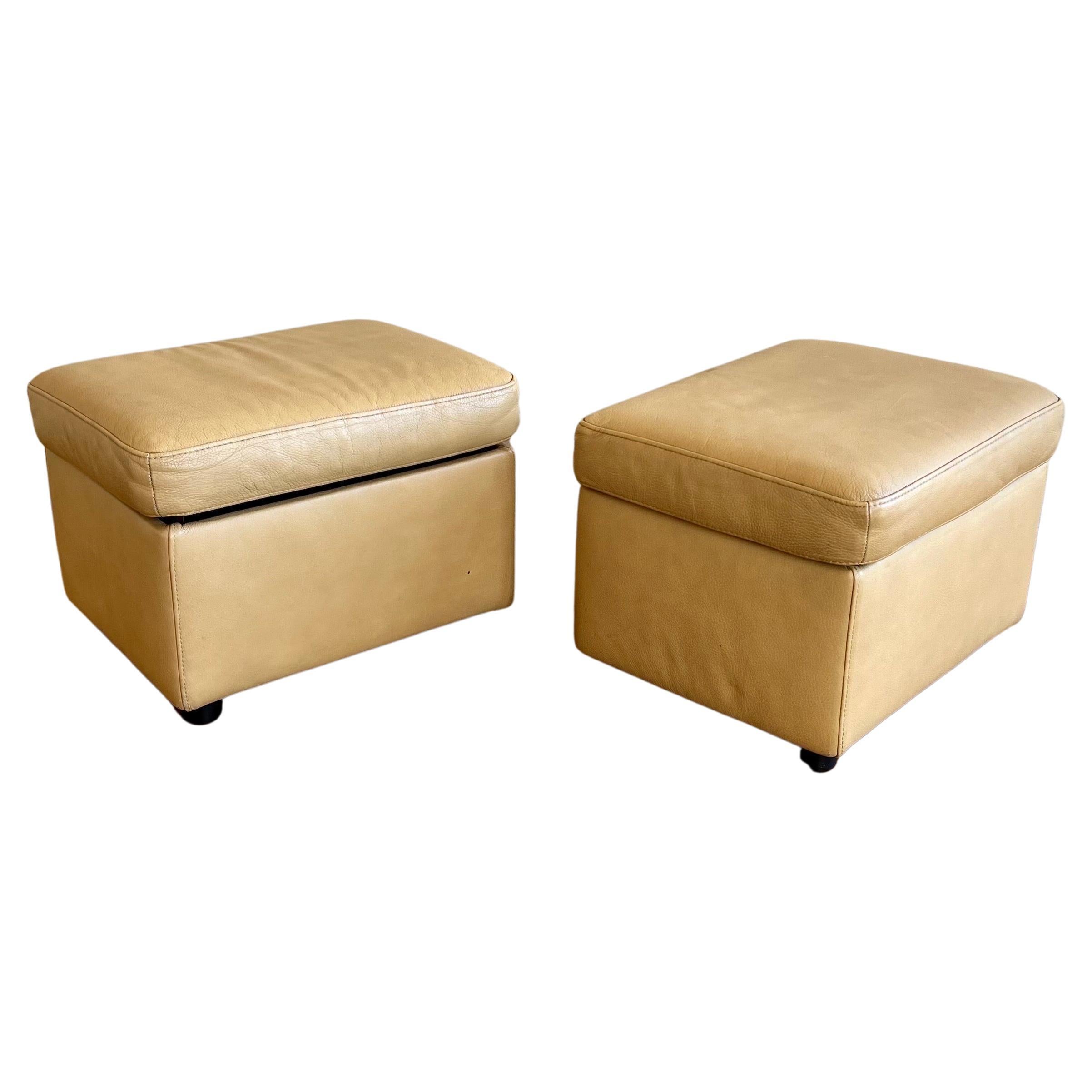 Pair of versatile leather ottomans by Ekornes with storage in a cream-yellow color, nice clean condition.