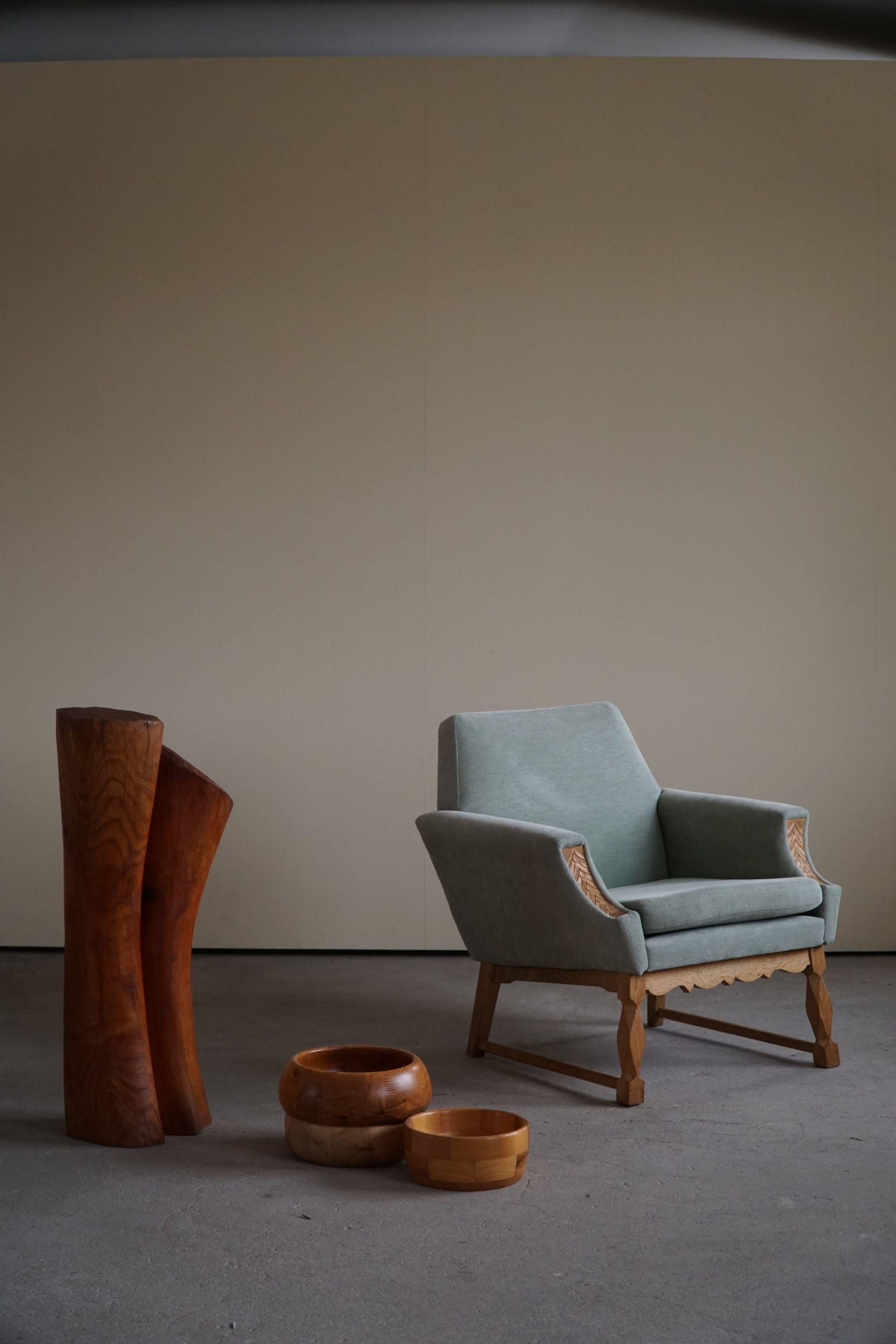 A decorative pair of mid century lounge chairs in turquoise/green velvet and solid oak. Made by a Danish Cabinetmaker in 1960s. Nice details, such as the carved armrest. 

These nice vintage chairs fits in many interior styles. Modern interior,
