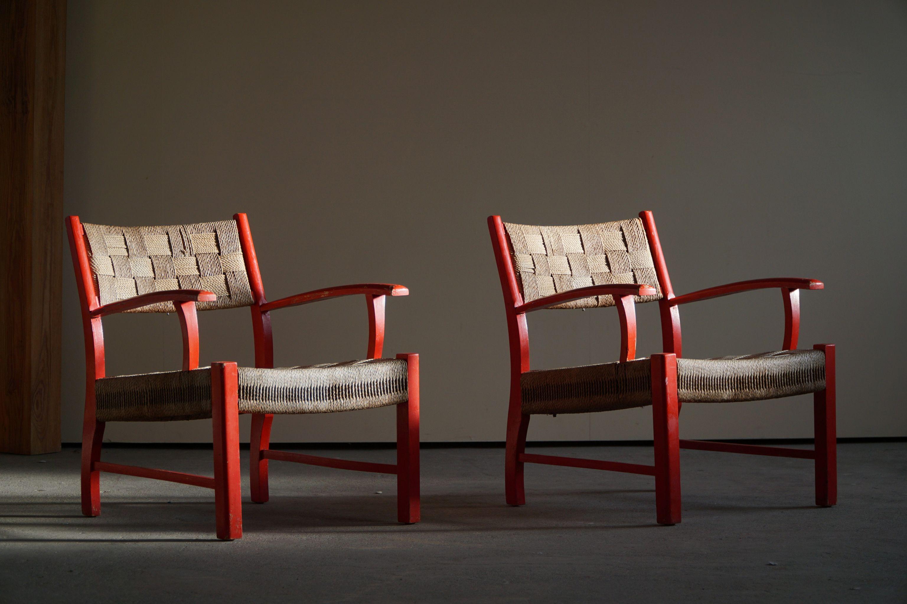 Pair of Danish armchairs in solid red lacquered beechwood and woven seagrass. Anonymous designer, manufactured by Fritz Hansen. It could be designed by either Karl Schröder or Frits Schlegel. Made in 1930's-40's.

This classic pair would fit many