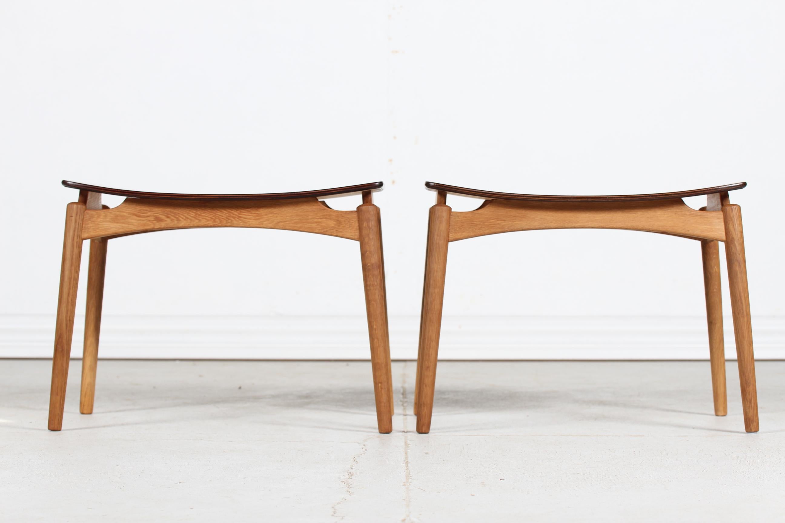 A pair of Danish Modern stools with floating seats manufactured by Sigfrid Omann made at Ølholm Møbelfabrik, Denmark in the 1960s.

The seats are made of steam bend teak veneer and the frames are of solid oak.
An elegant and high quality example