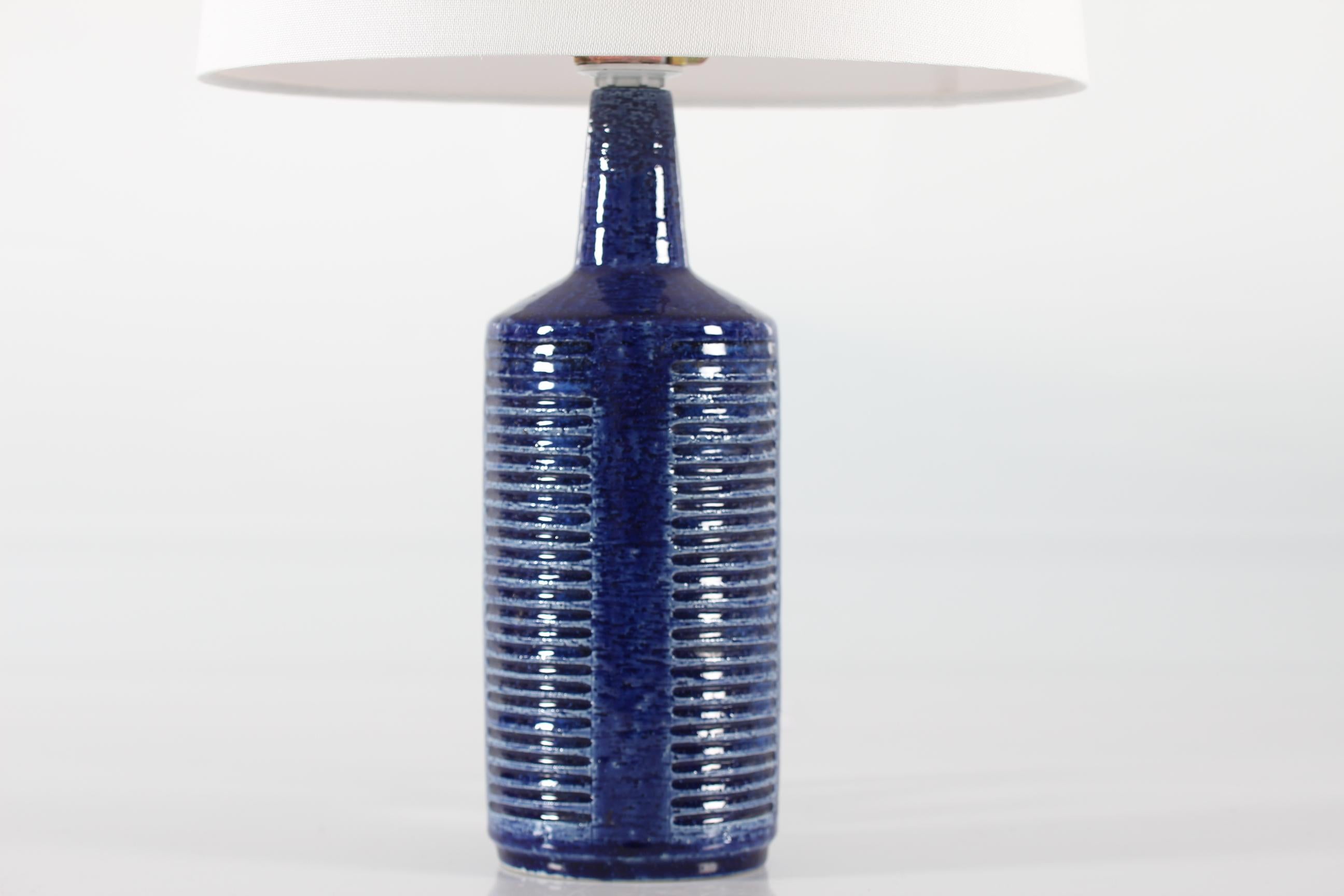 Midcentury table lamp from Danish Palshus model no. DL30.
The lamp was designed by Per Linnemann-Schmidt and produced, circa 1960s.
It is made of chamotte clay which gives a rough and vivid surface. The glaze is cobalt blue.

Included is a new