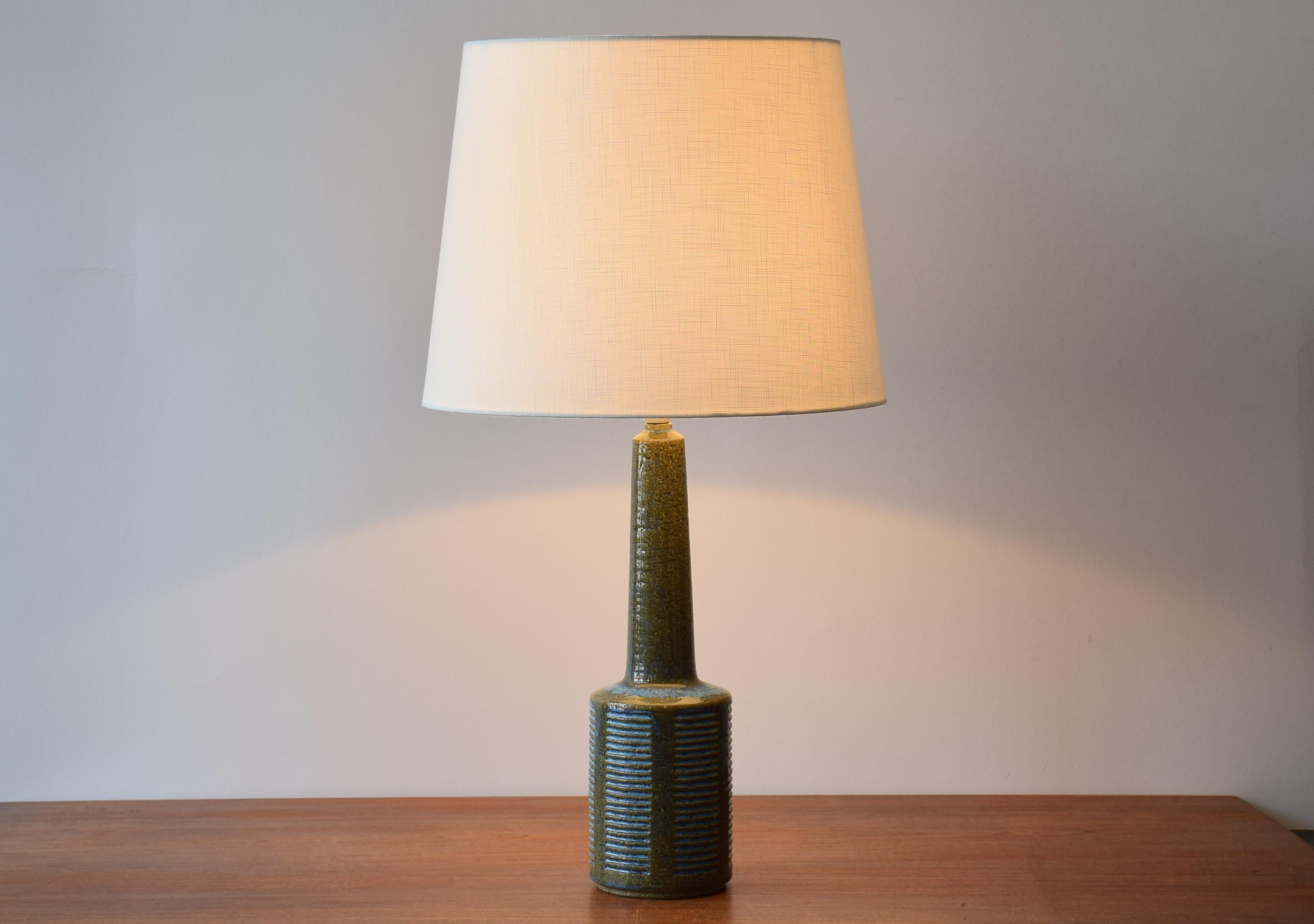 Midcentury tall table lamp from Danish Palshus.
The lamp was designed by Per Linnemann-Schmidt and produced, circa 1960s.
It is made with chamotte clay which gives a rough and vivid surface. The glaze is moss green with pale blue.

Included is a