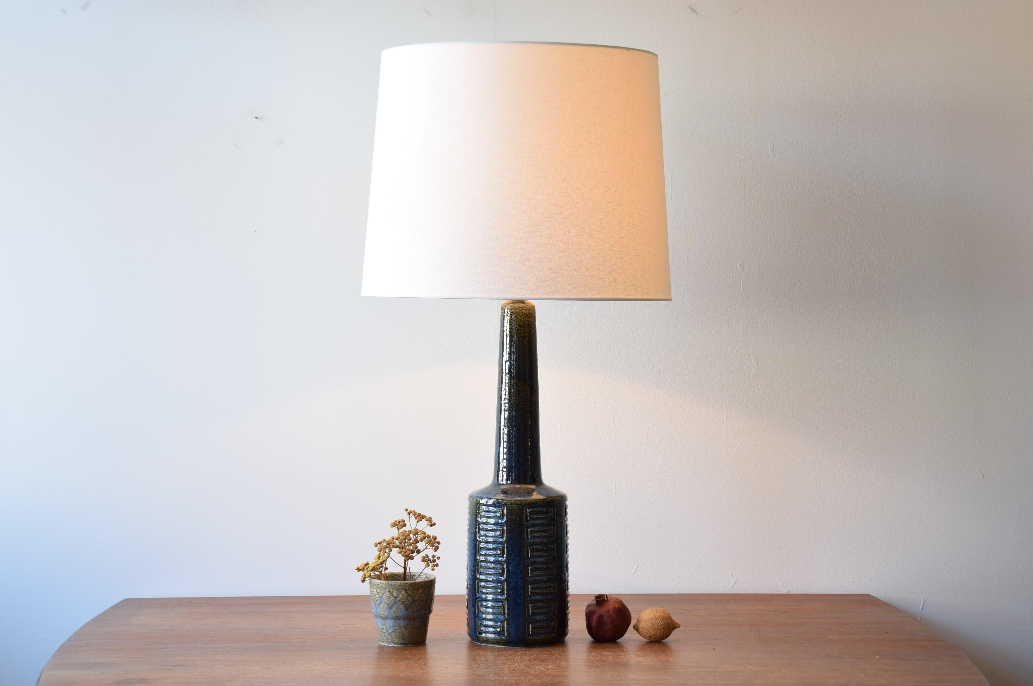 Very tall Danish Midcentury ceramic table lamp from Palshus including lamp shade.
The lamp was designed by Per Linnemann-Schmidt and manufactured circa 1960s or early 1970s.
It is made with chamotte clay which gives a rough and vivid surface. The