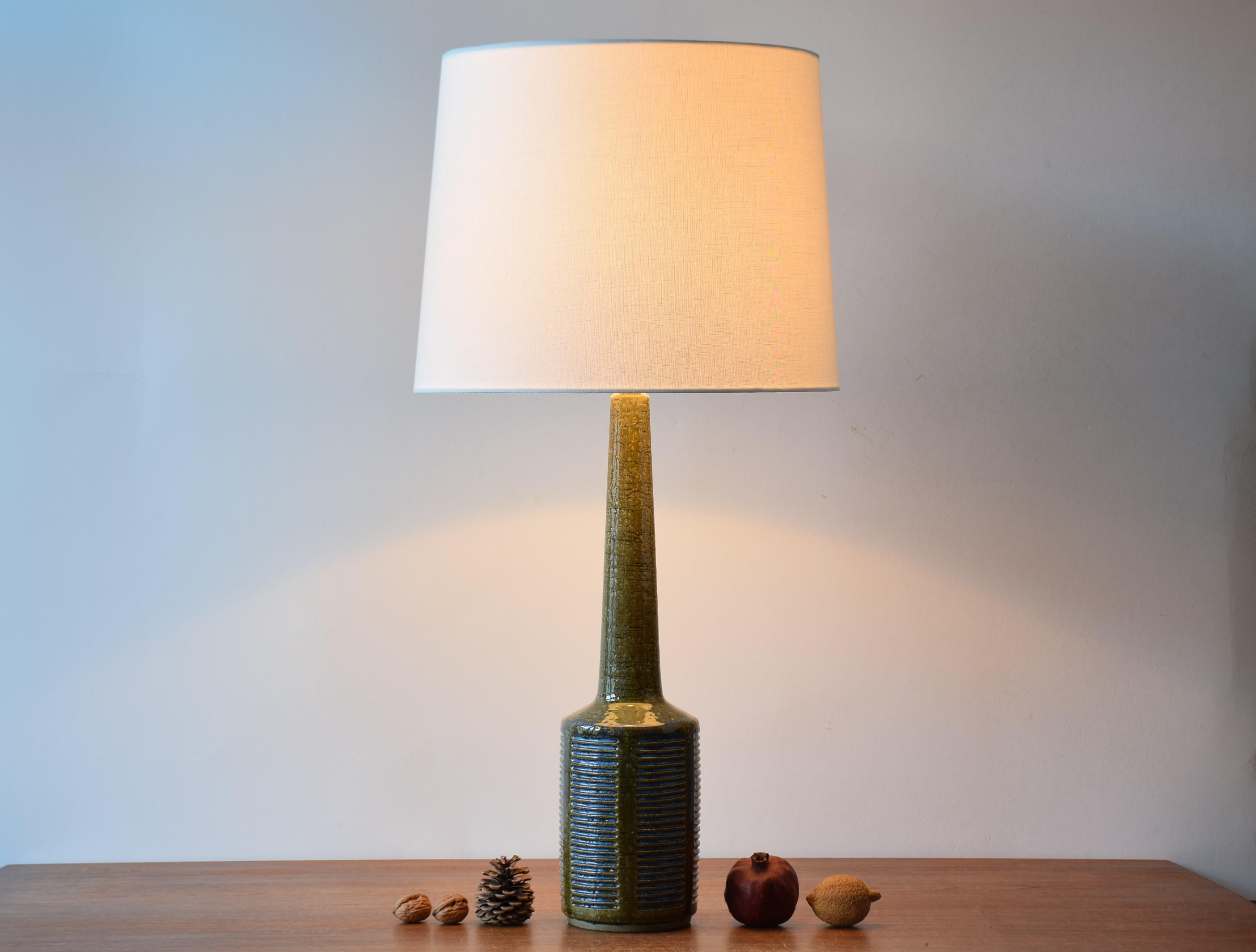 Very tall midcentury table lamp from Danish Palshus.
The lamp was designed by Per Linnemann-Schmidt and produced, circa 1960s.
It is made with chamotte clay which gives a rough and vivid surface. The glaze is moss green with pale blue.

Included is