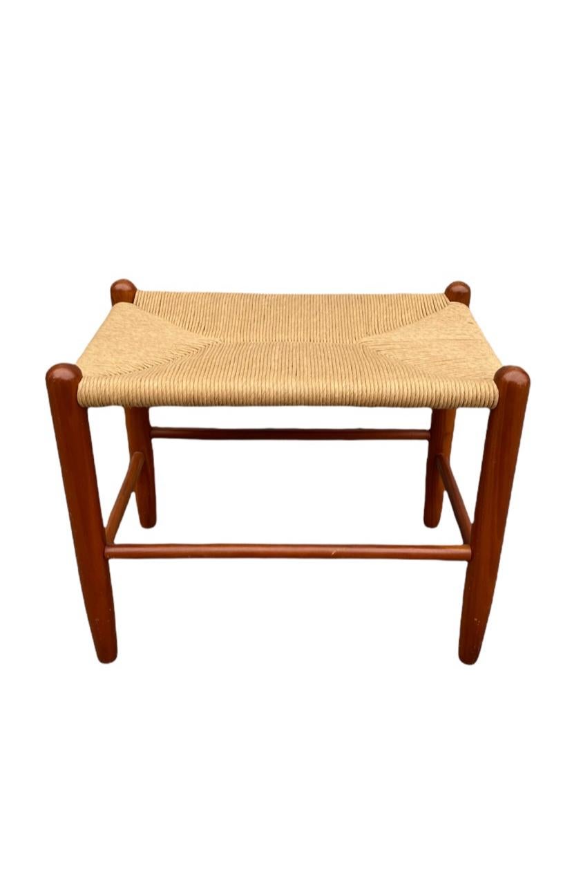 Versatile Danish modern bench or foot stool with new hand woven paper cord. Solid wood construction is very sturdy. The stool measures 23” wide, 15” deep, and 18” tall with a seat height of 17”.