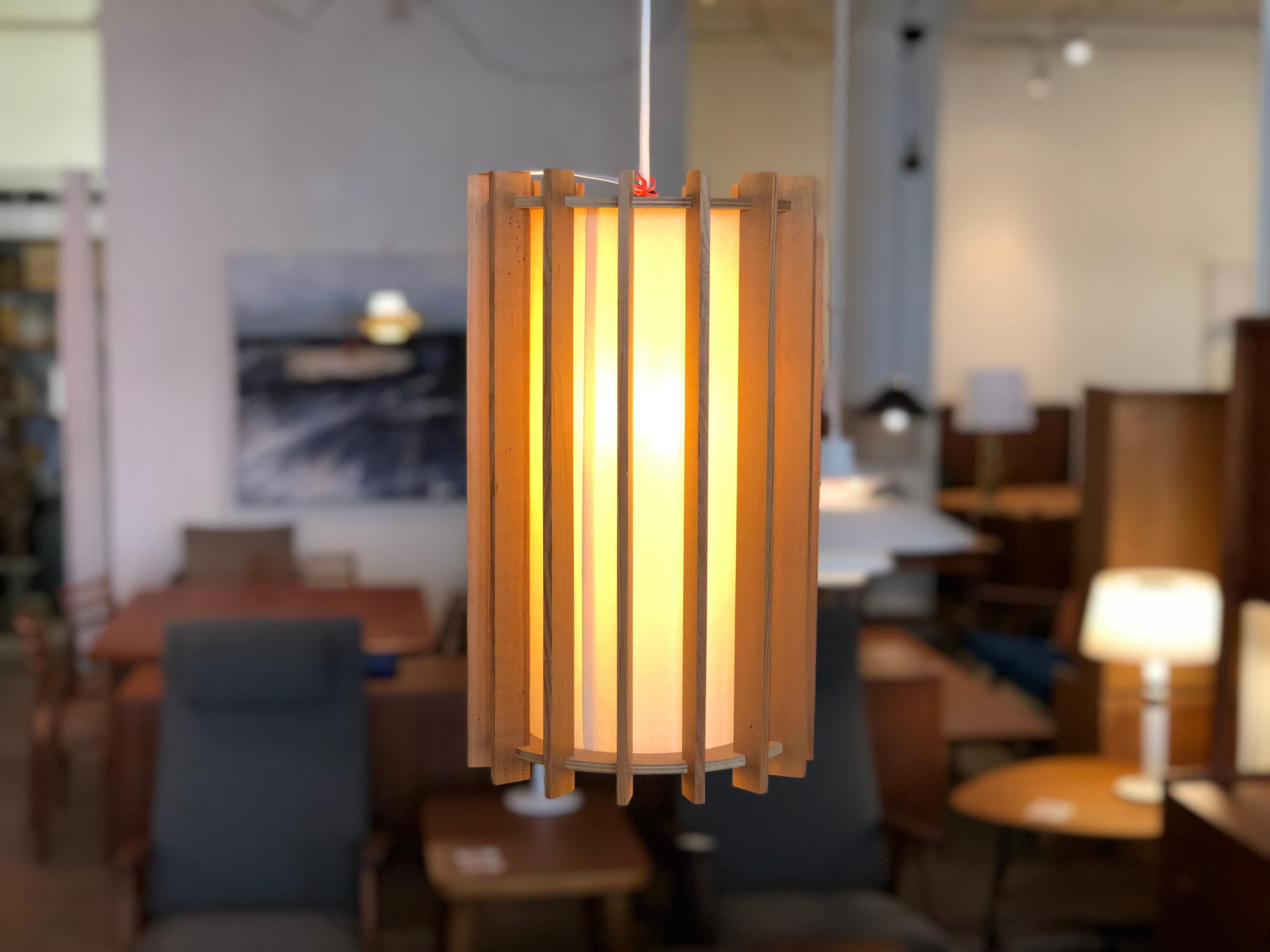 This conical piece boasts a fir slat exoskeleton and a linen shade lining inside. When light is on the fixture has a soft diffuse glow, a great accent for any modernist contemporary setting.

Professional, skilled furniture restoration is an