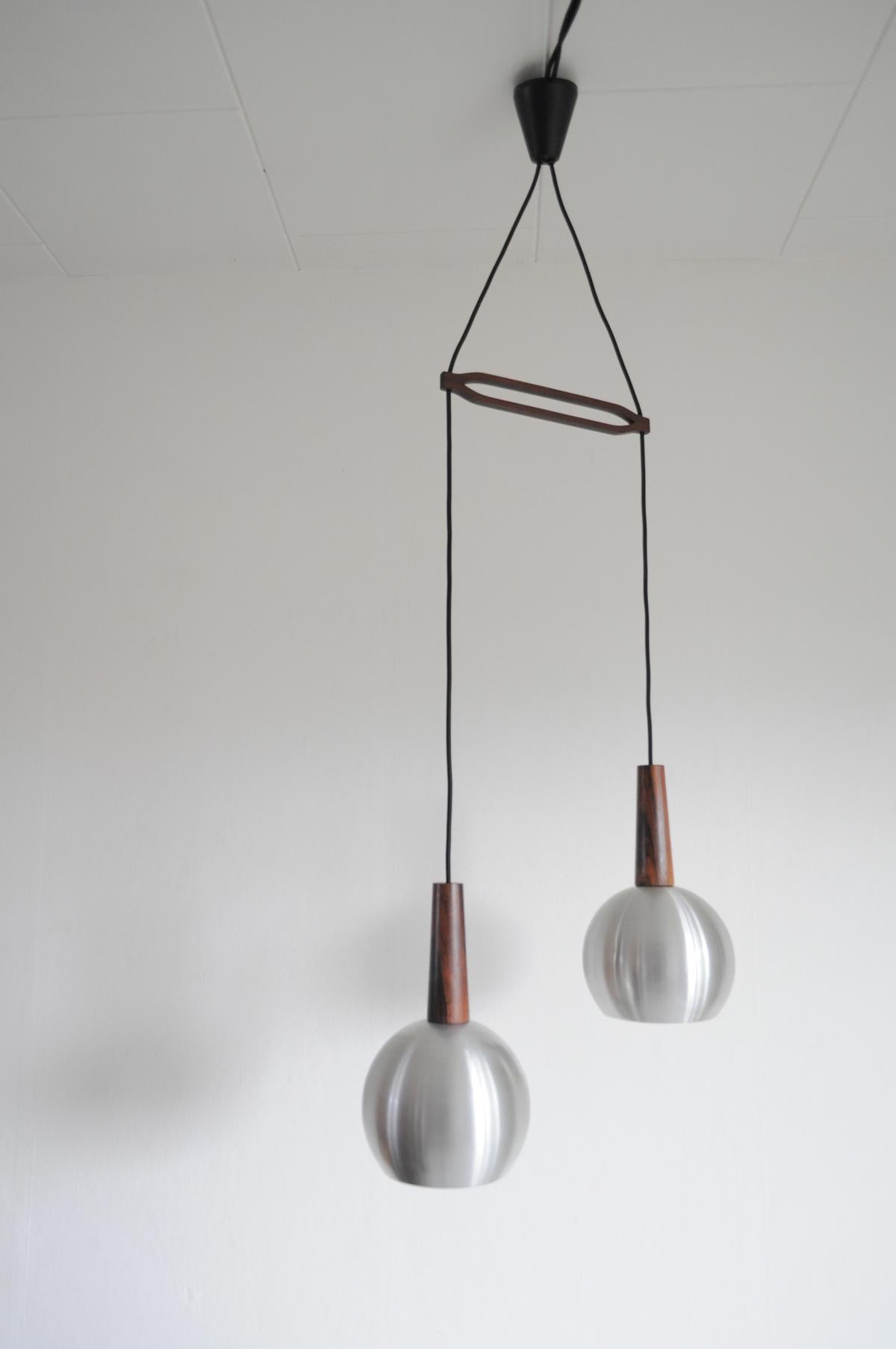 Danish Modern pendant lamps with details in rosewood in the style of Verner Panton from the 1960s.
Signs of wear consistent with age and use. We recommend repainting of the innershade, please contact us regarding this.

Dimensions:
Full length as
