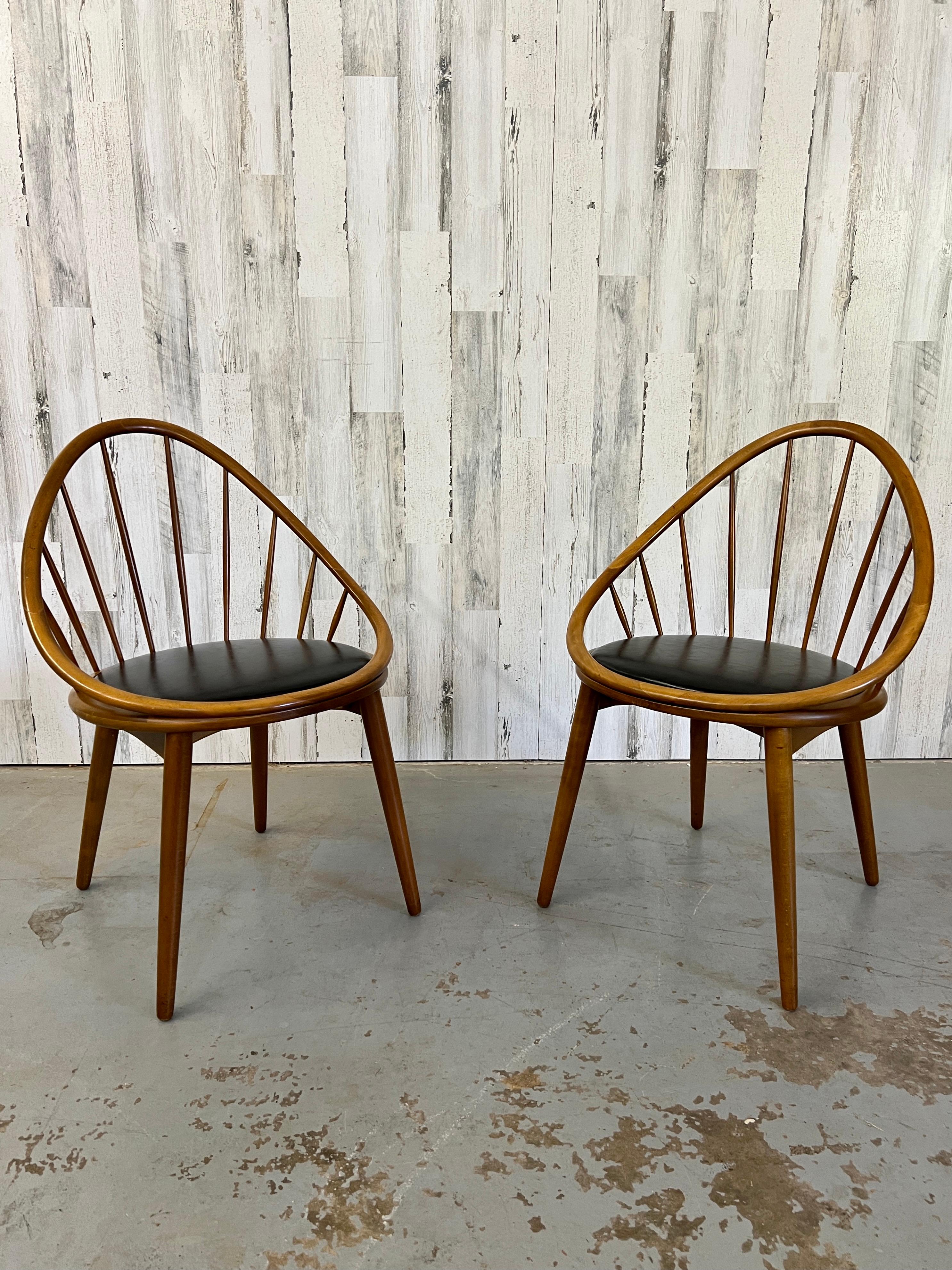 Solid Beech wood spindle back hoop chairs in the style Kofed Larsen with original vinyl seats.