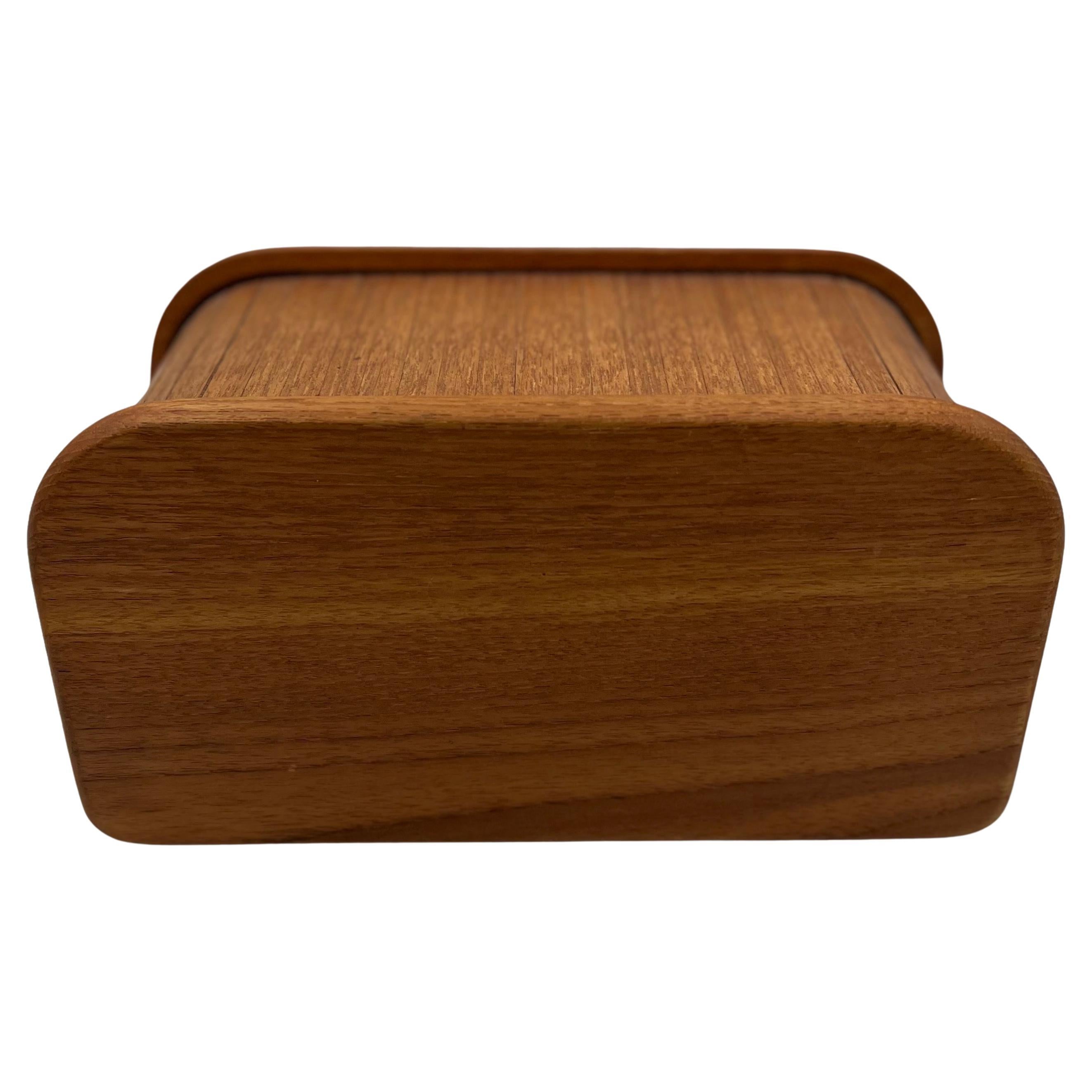 Small Danish modern solid teak tambour door trinket box, circa the 1970s. This beautiful well crafted roll-top desk box is great for trinkets or storage. The piece is in very good vintage condition.