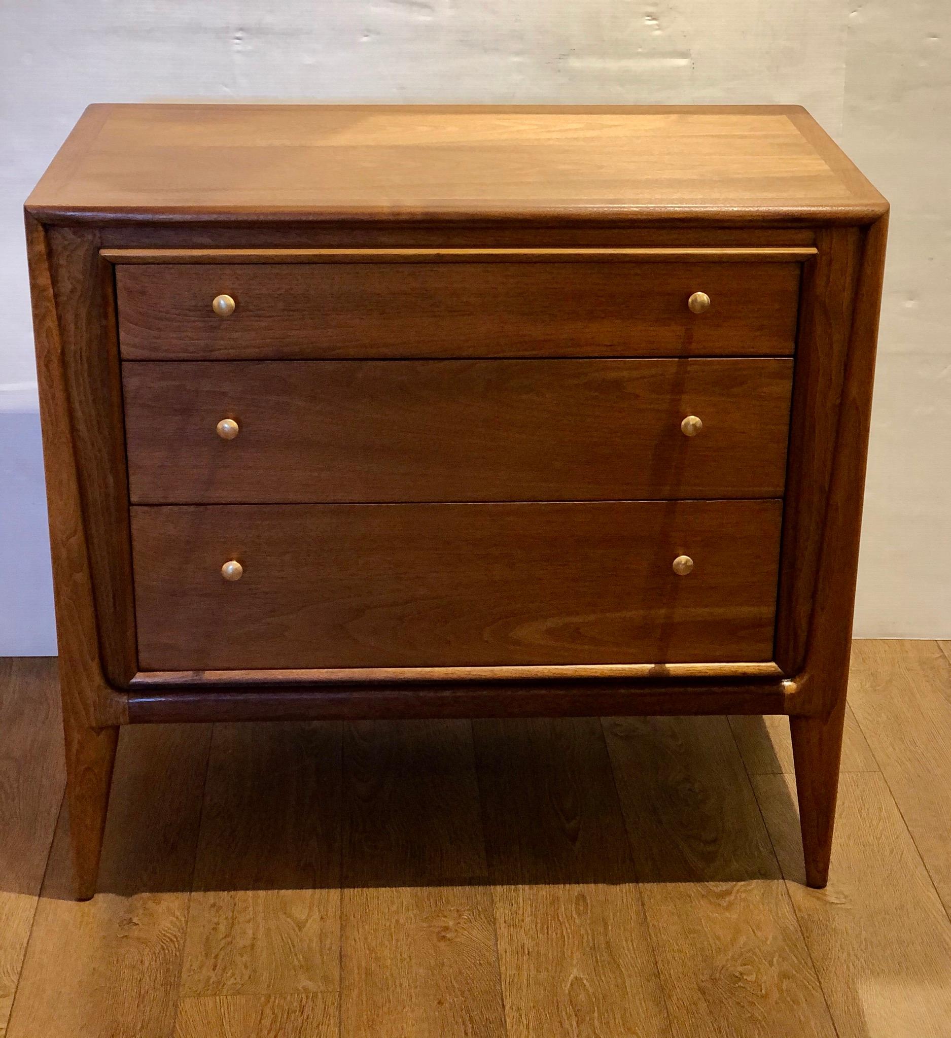 Beautiful simple elegant small dresser by John Stuart, circa 1960s freshly refinished with brass polished handles.