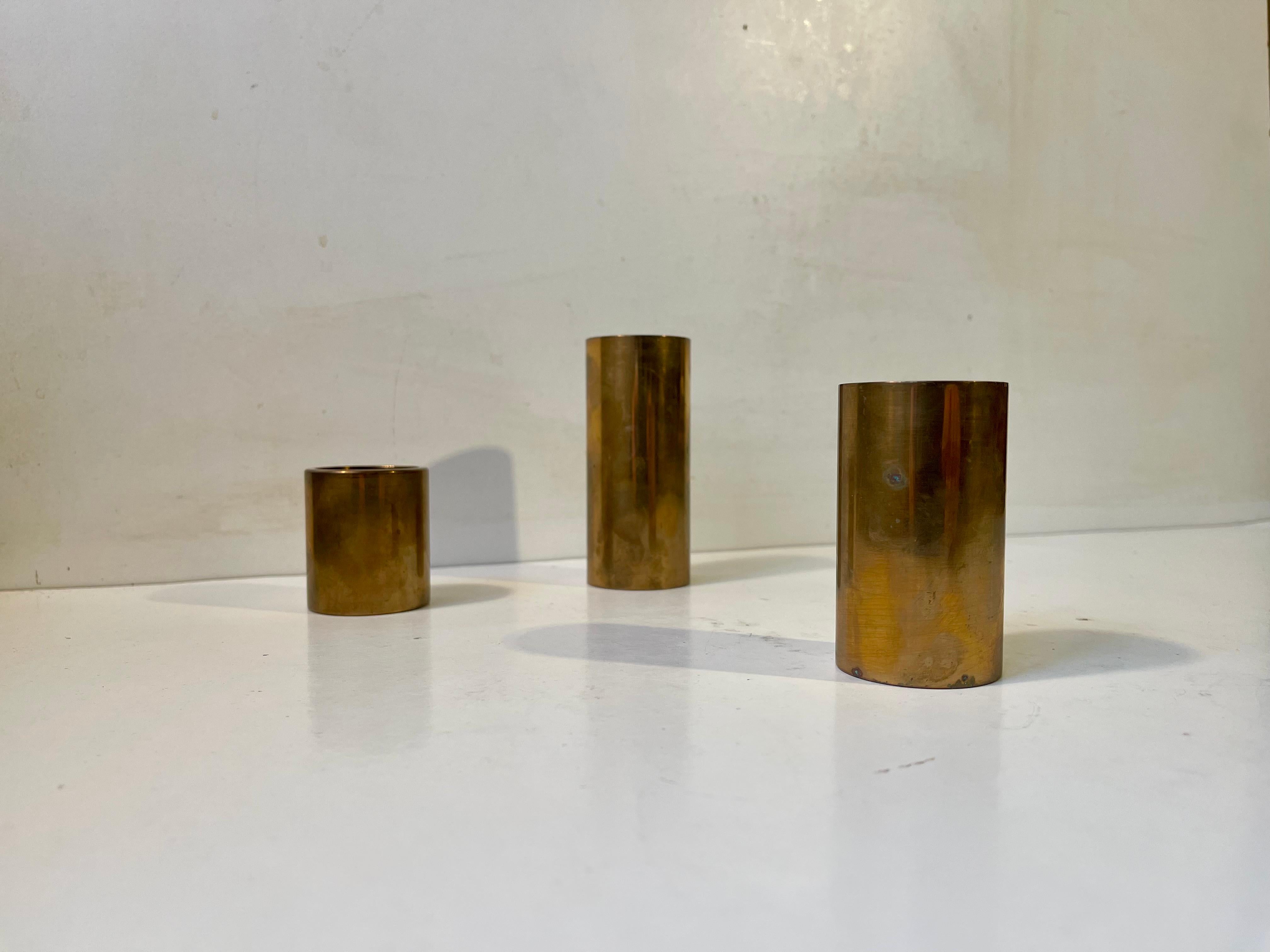 A set of 3 danish modern chimney shaped candleholders. Made from heavy stock patinated bronze. Great Nautical/maritime/industrial vibe to them. They can be installed with either tea light candles or church/bloc candles. Made in Denmark during the