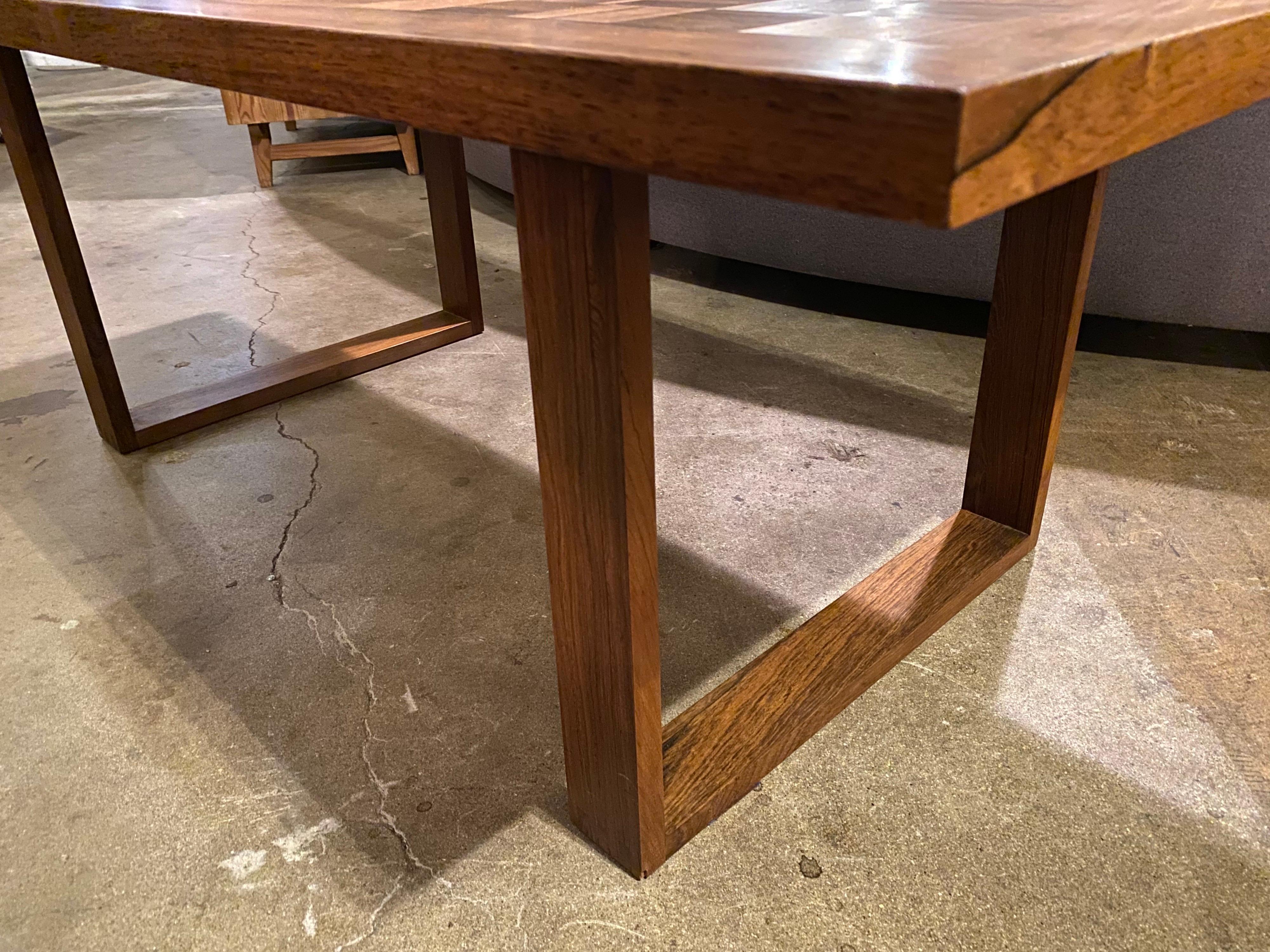 Scandanavian modern rosewood coffee table by Poul Cadovius features a parquet or chess pattern. This mid-century modern coffee table is in good vintage condition.