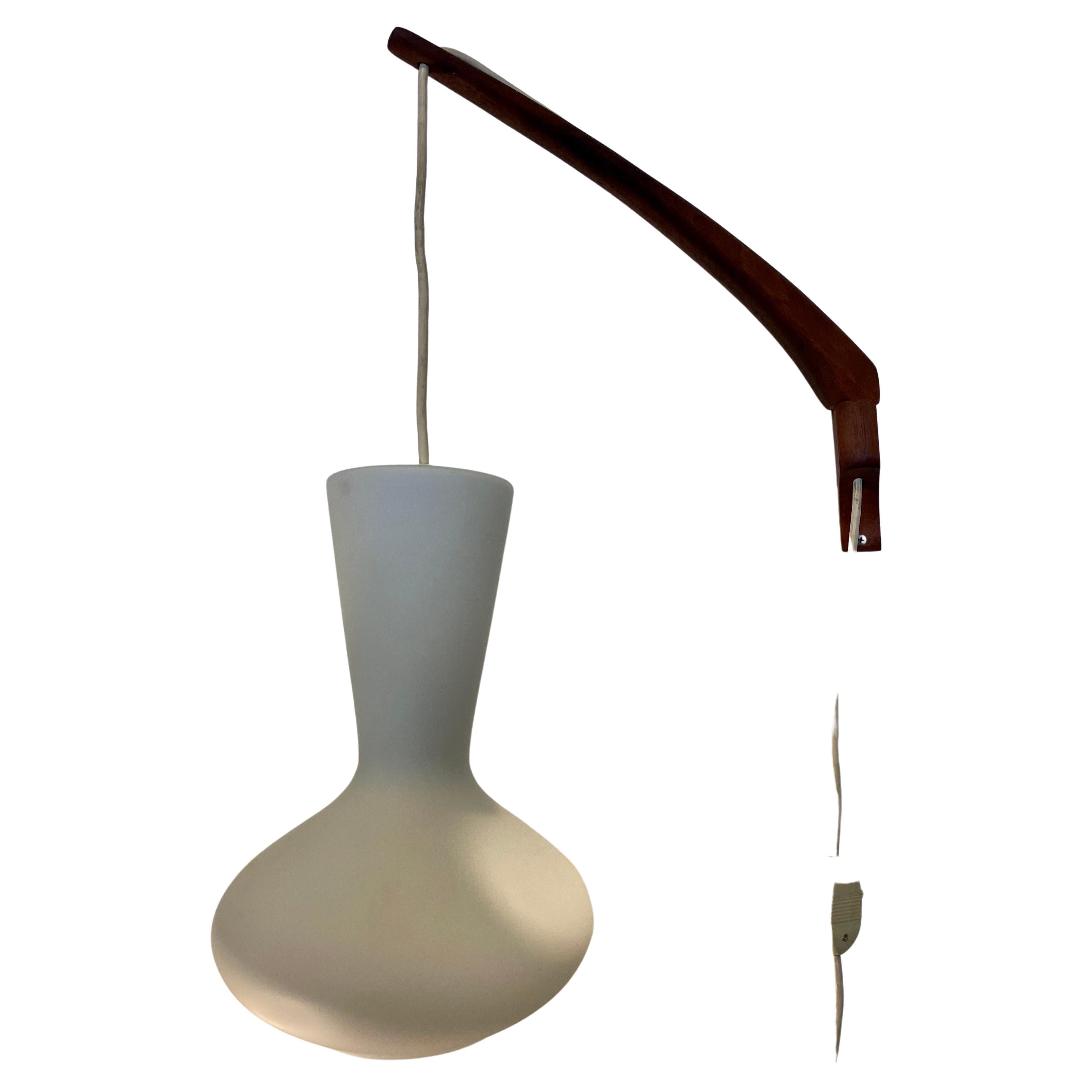 A very rare glass swag lamp designed by Lisa Johansson-Pape with solid teak arm and plug-in cord with switch integrated, excellent condition and working perfectly, circa 1950's , the glass shade its 12